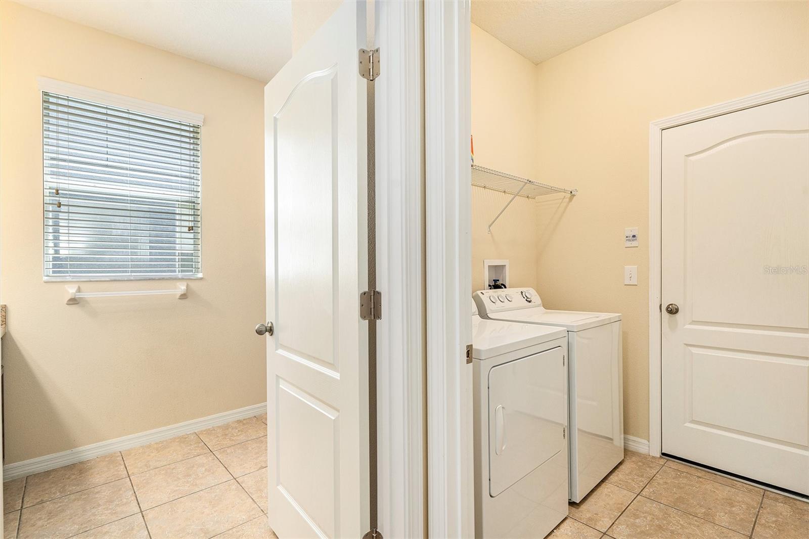 downstairs bedroom and laundry room near the garage door