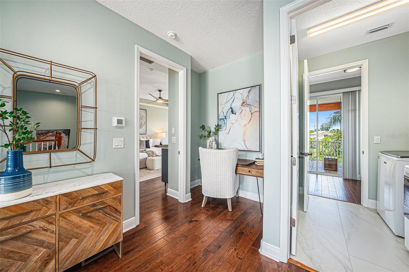 Landing on the second floor with Primary Bedroom to the left and laundry straight ahead with access to the oversized lanai with hot tub!