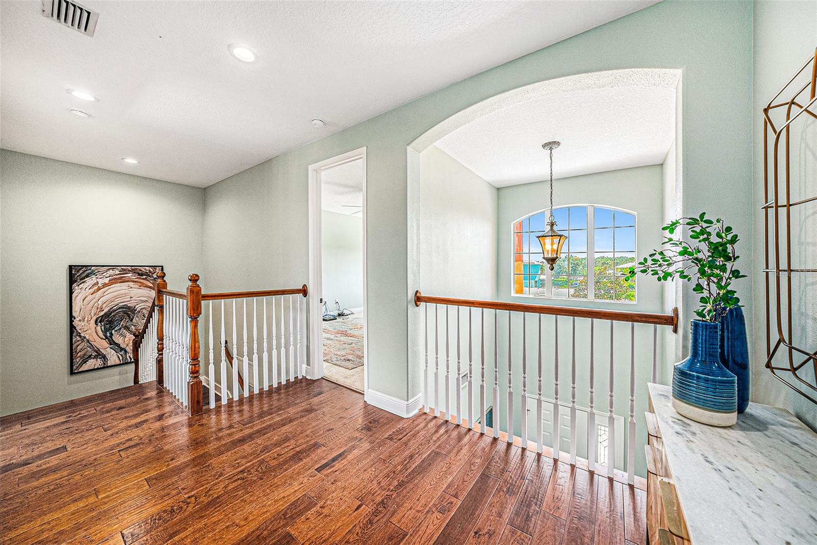 Landing top of stairs that overlooks the foyer