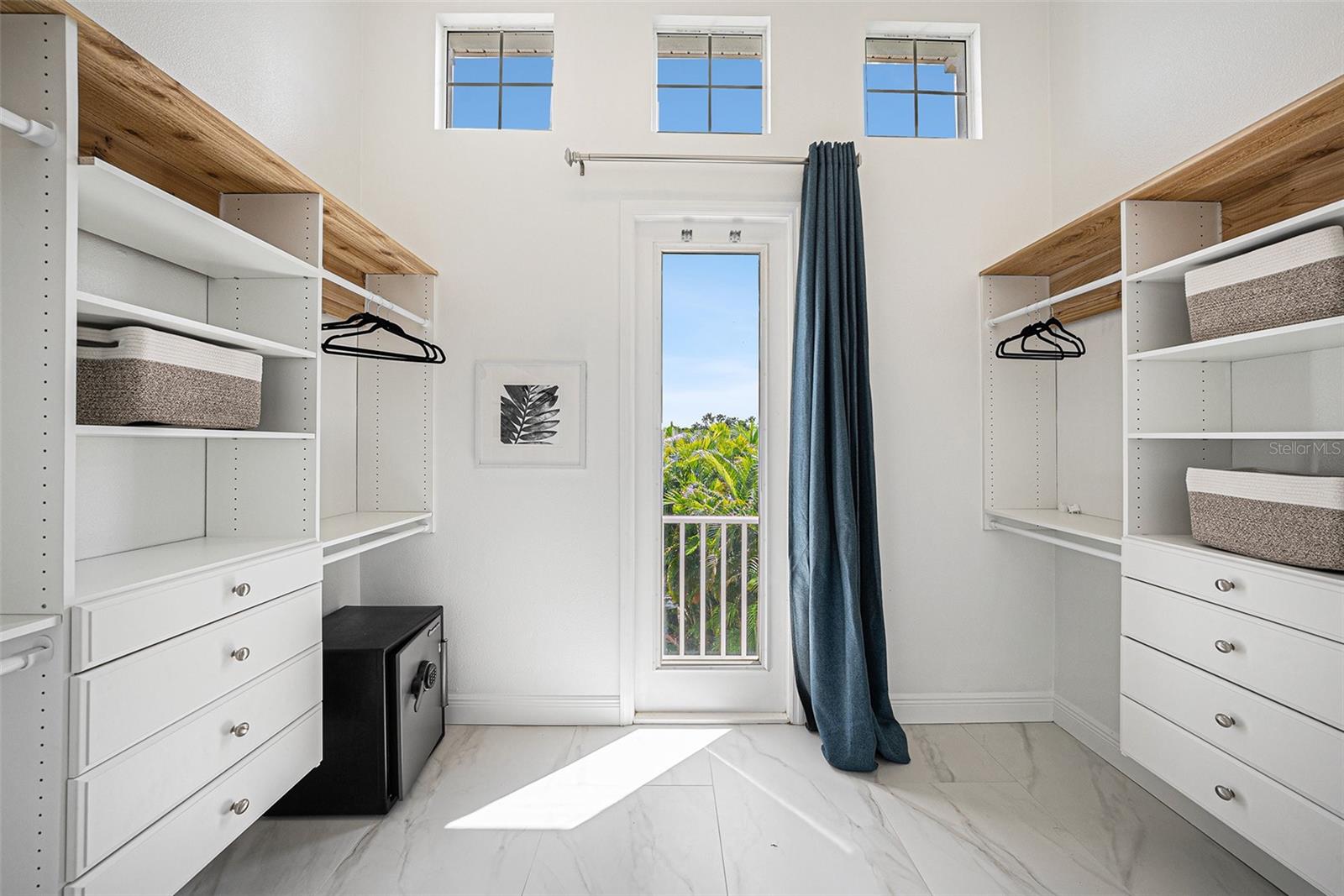 Primary bedroom walk in closet