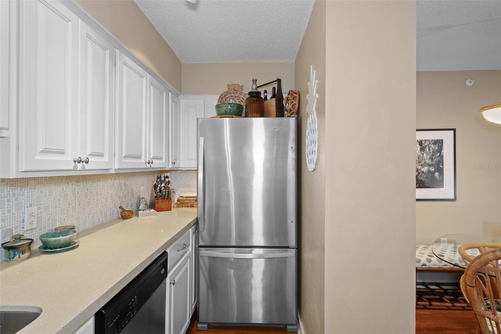 This kitchen offers an abundance of cabinets and quartz counter top space