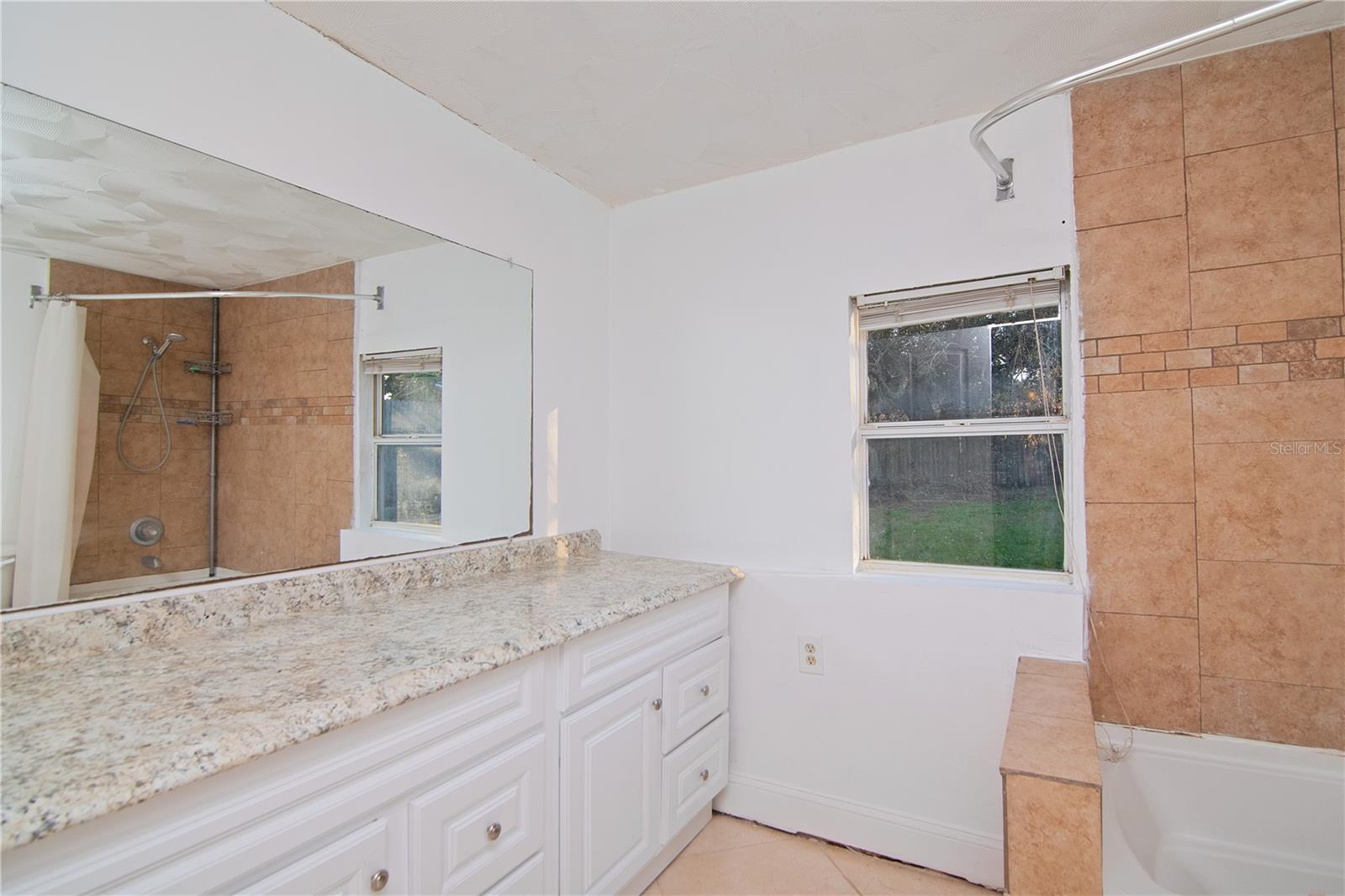 This spacious bathroom offers plenty of storage too!