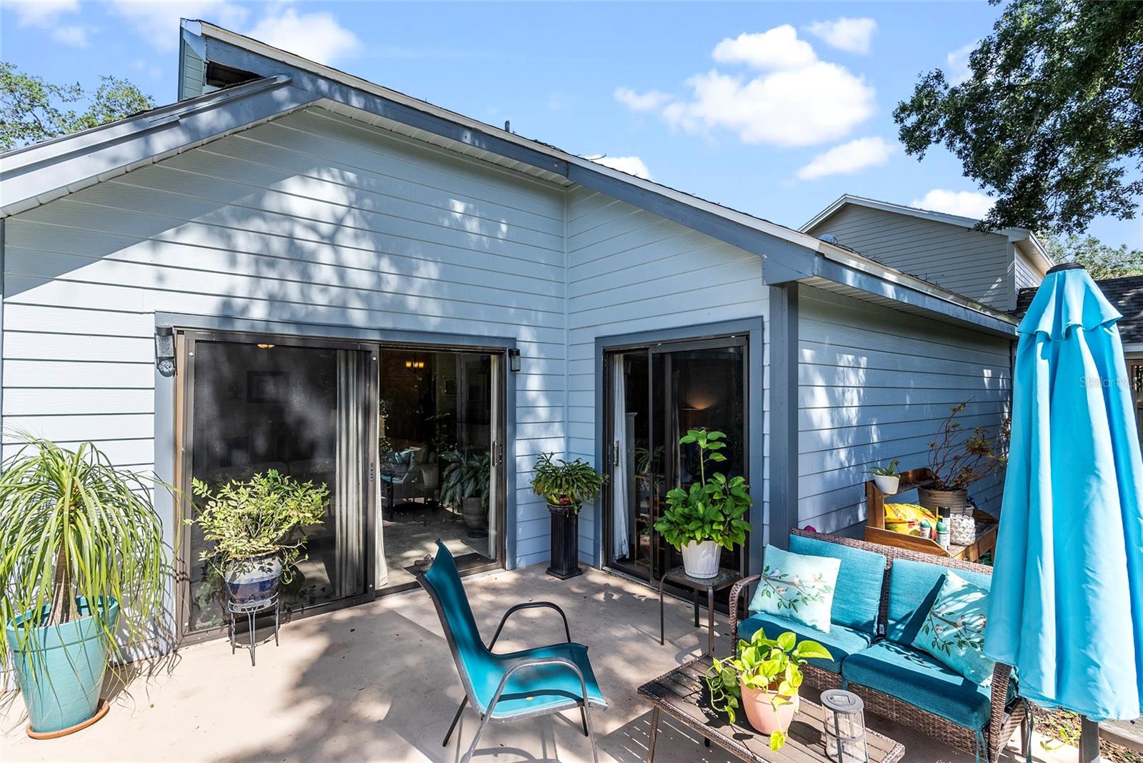 Back of the house.  The sliding glass doors on the left lead into the living room and the sliding glass doors on the right lead into the primary bedroom