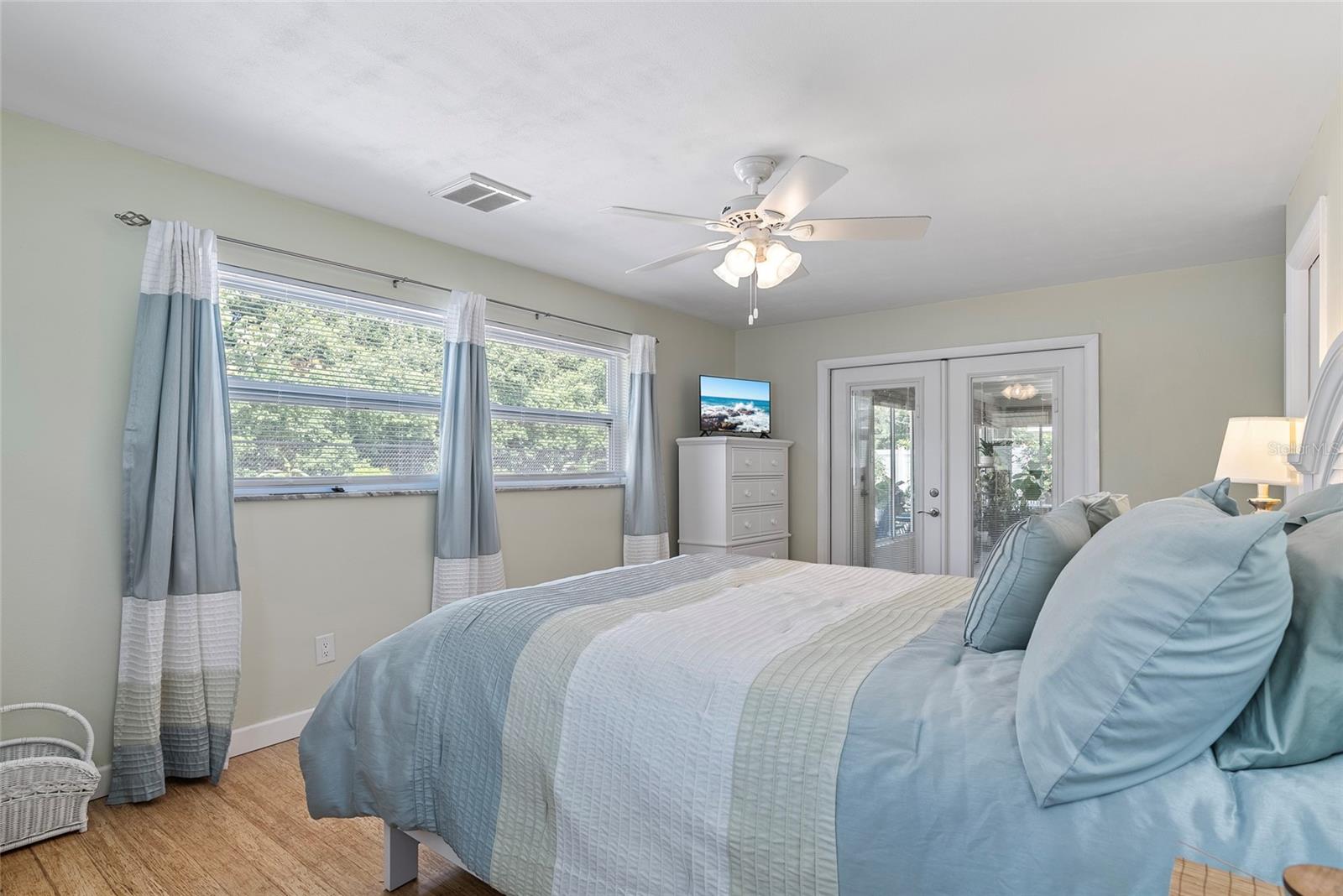 French doors lead from primary bedroom to the bonus room