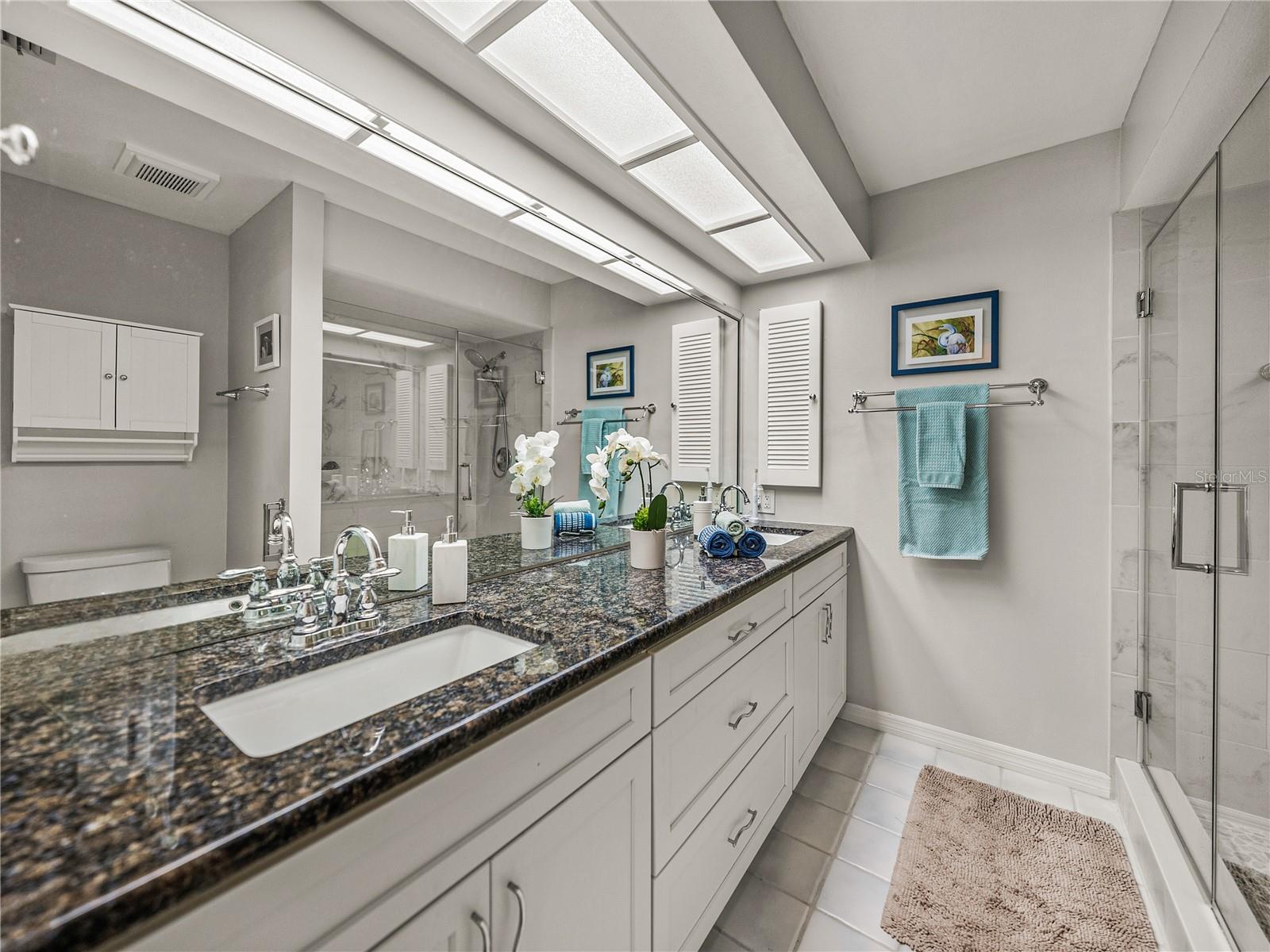 Updated en-suite with granite, dual vanity, and lovely lighting~