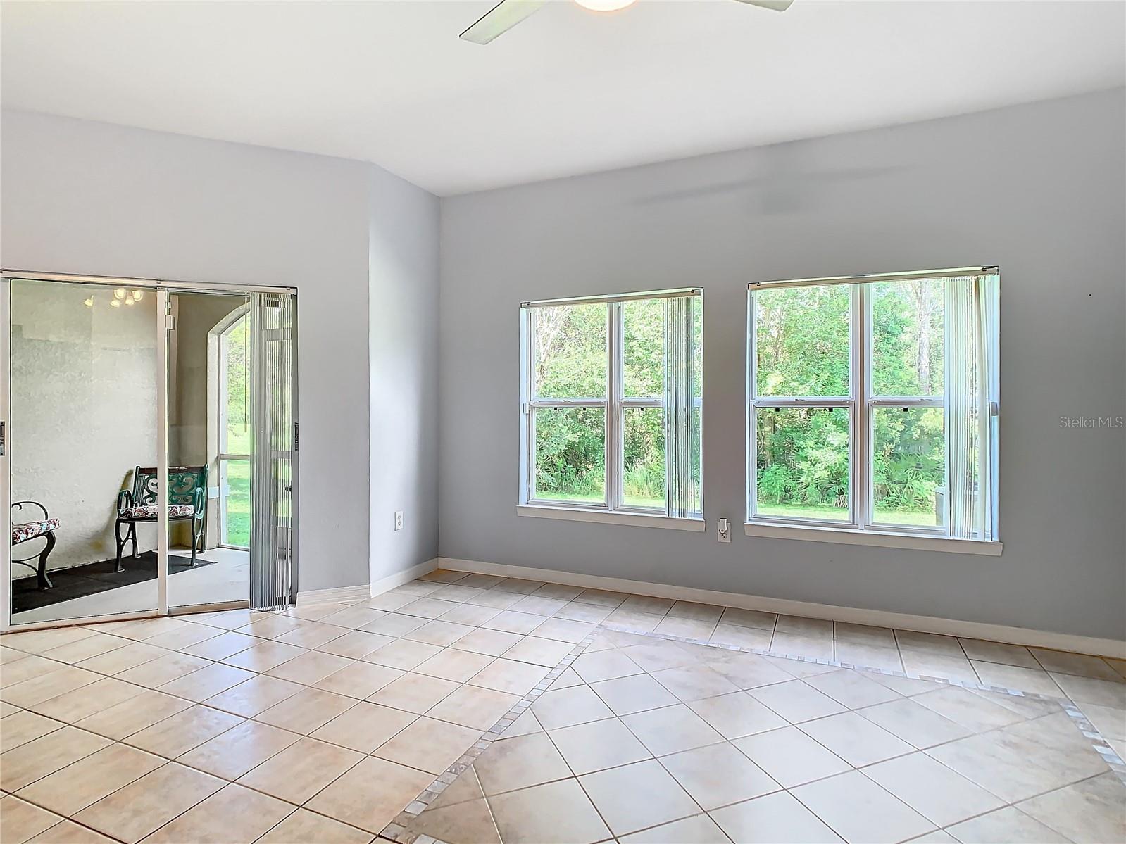 Large windows let in lots of light.  Screened, covered patio through sliding doors.