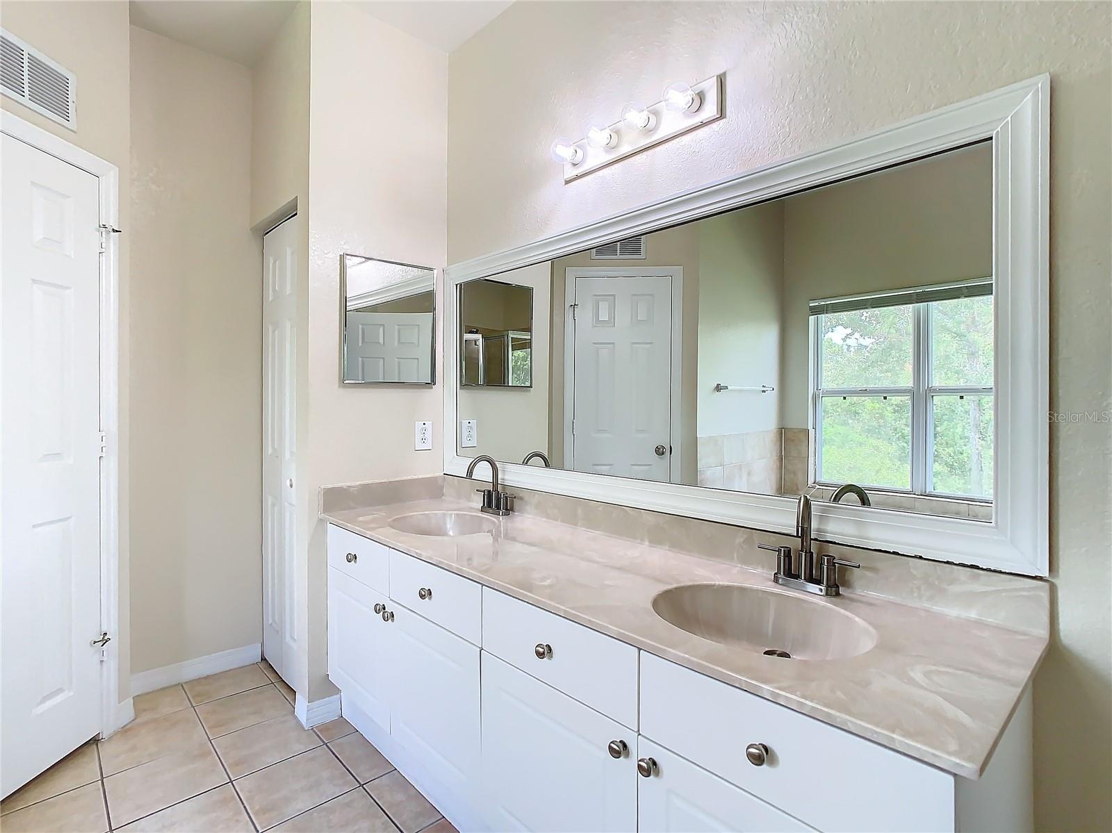 Primary bath with dual sinks & separate water closet.