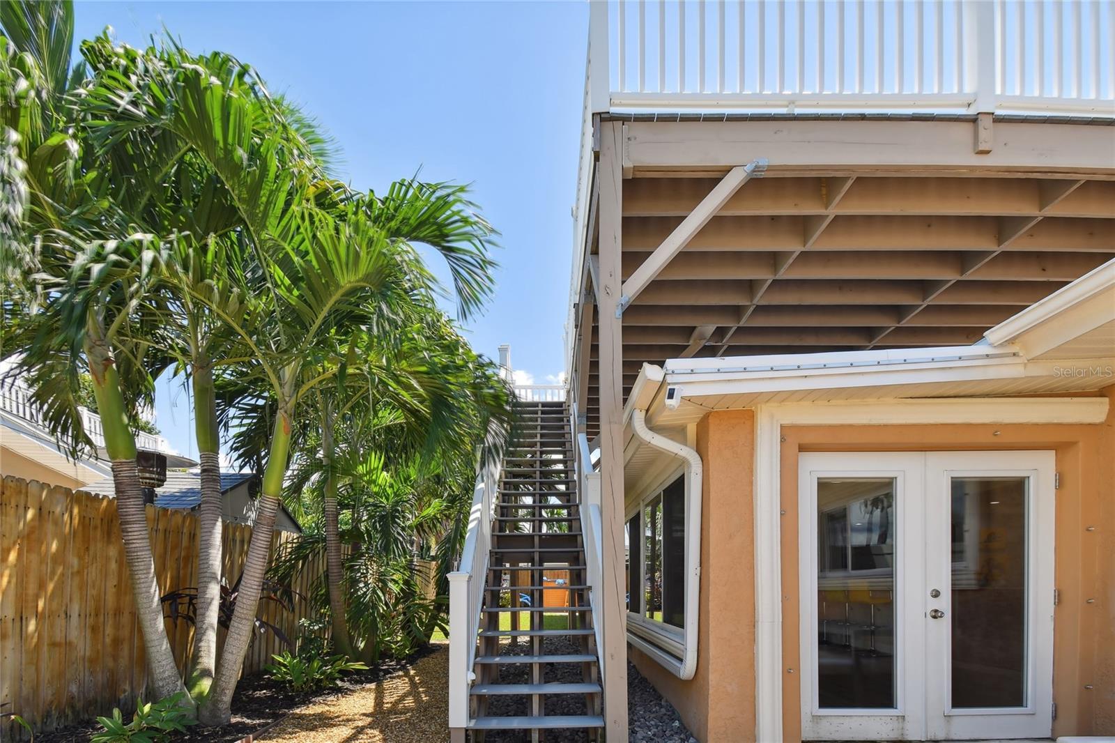 north end of the back. yard with stairs to big deck, French doors into the family room.