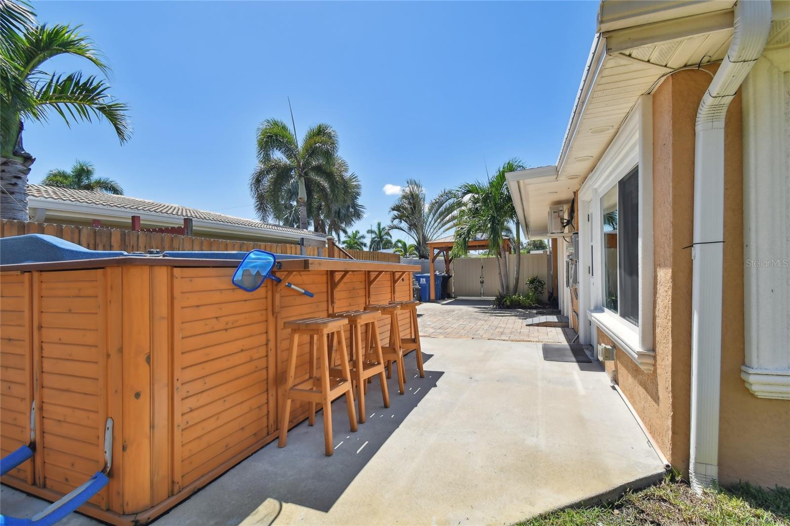 Large swim spa and south side patio.  Entrance to the efficiency on the right with bathroom which could be used for the swim spa changing and shower area.