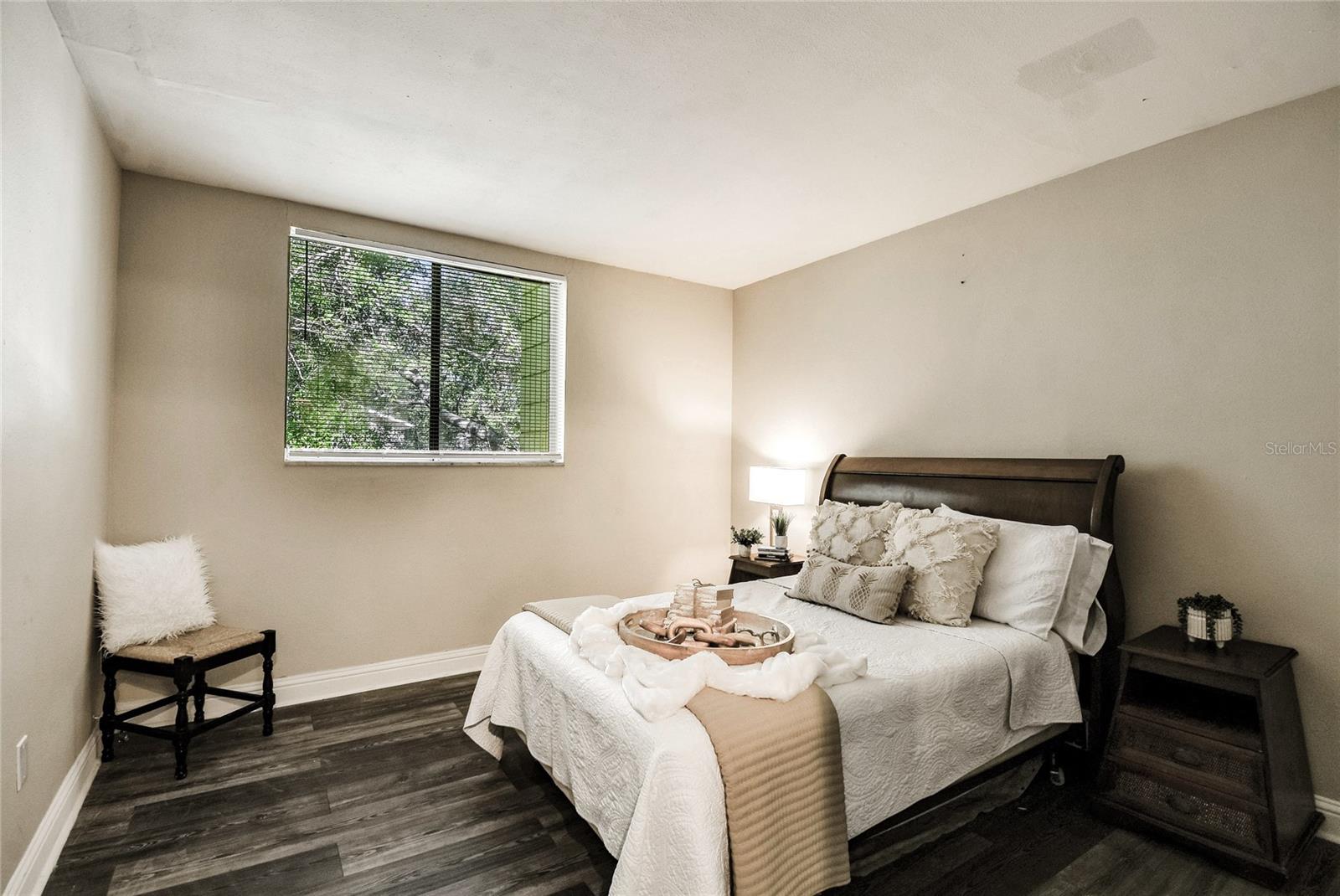 Primary bedroom with peaceful green views out the window