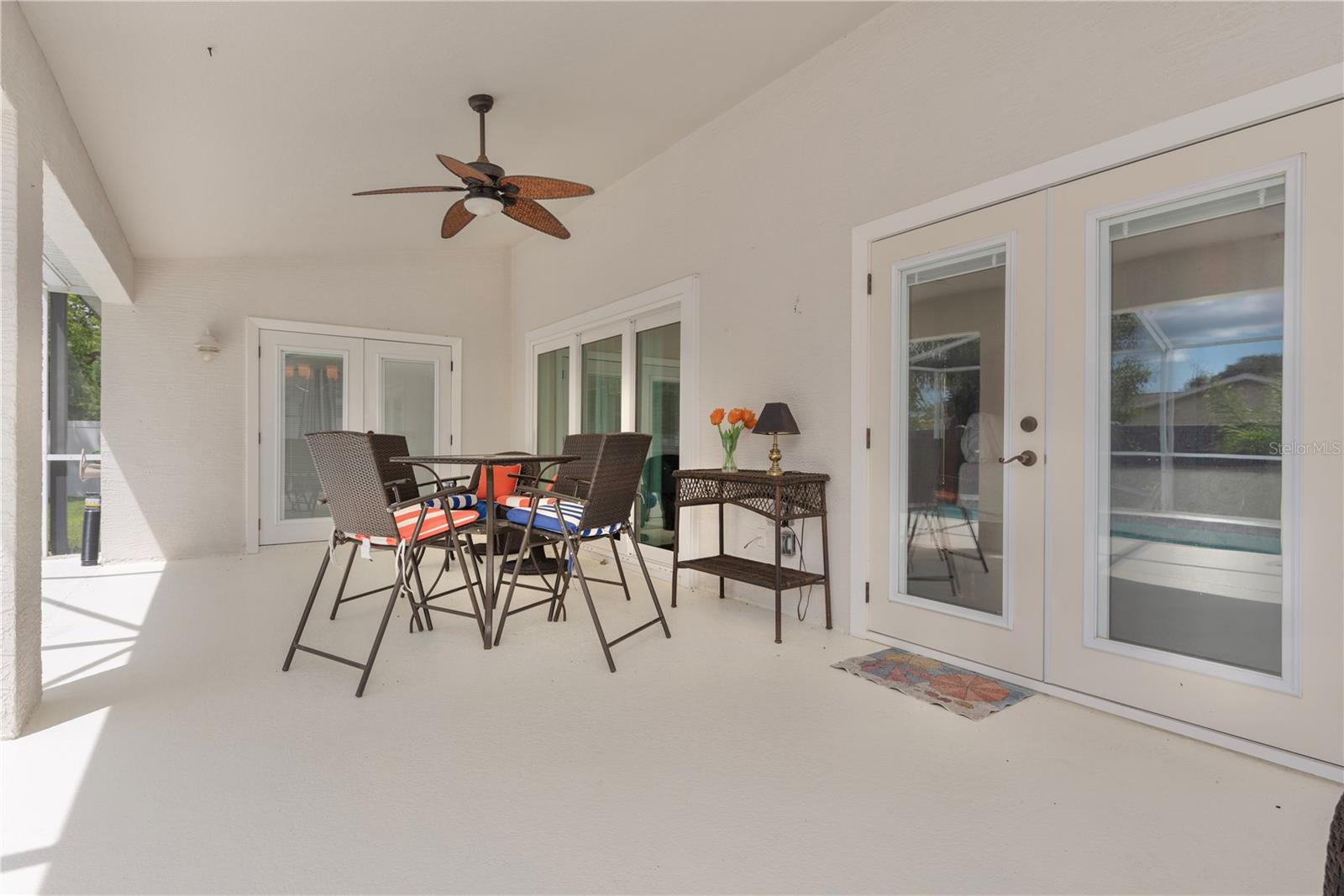 Doors leading to breakfast nook, living room, & primary bedroom from pool lanai.