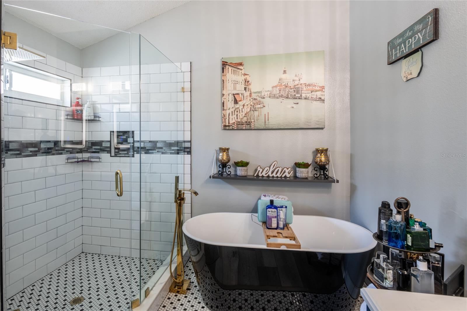 Stand alone tub with glass walk in shower.