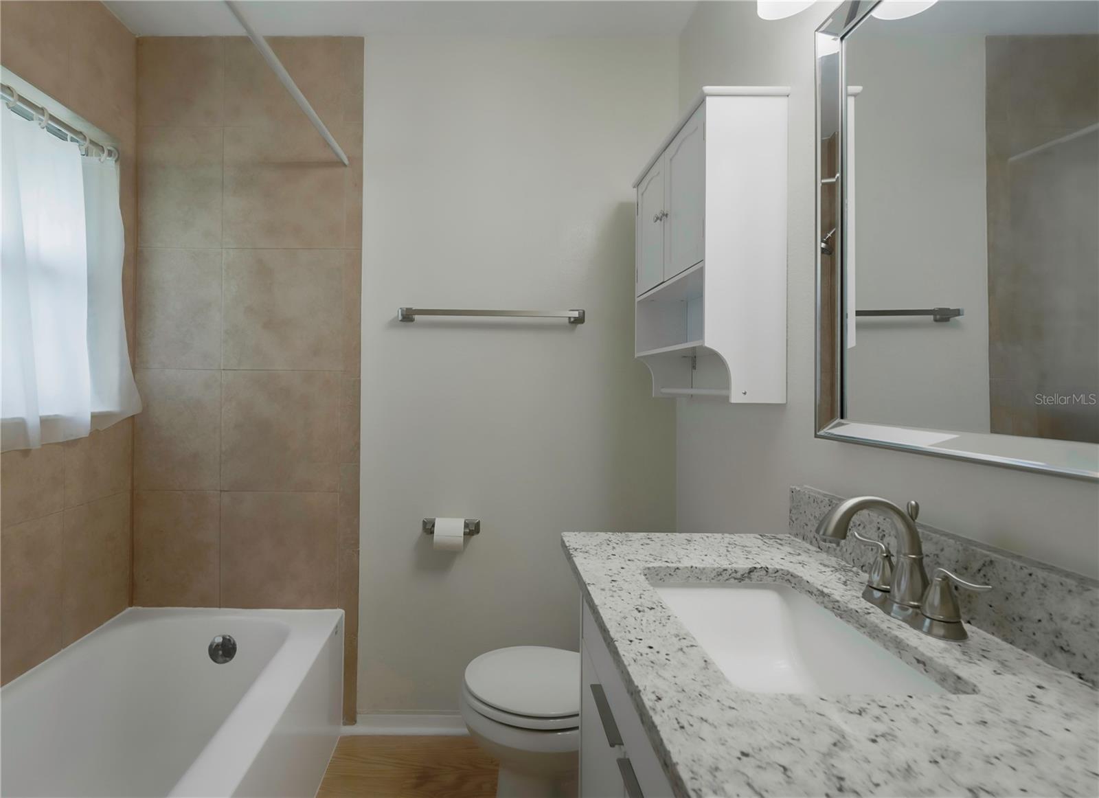 new tub, vanity with granite counters, toilet