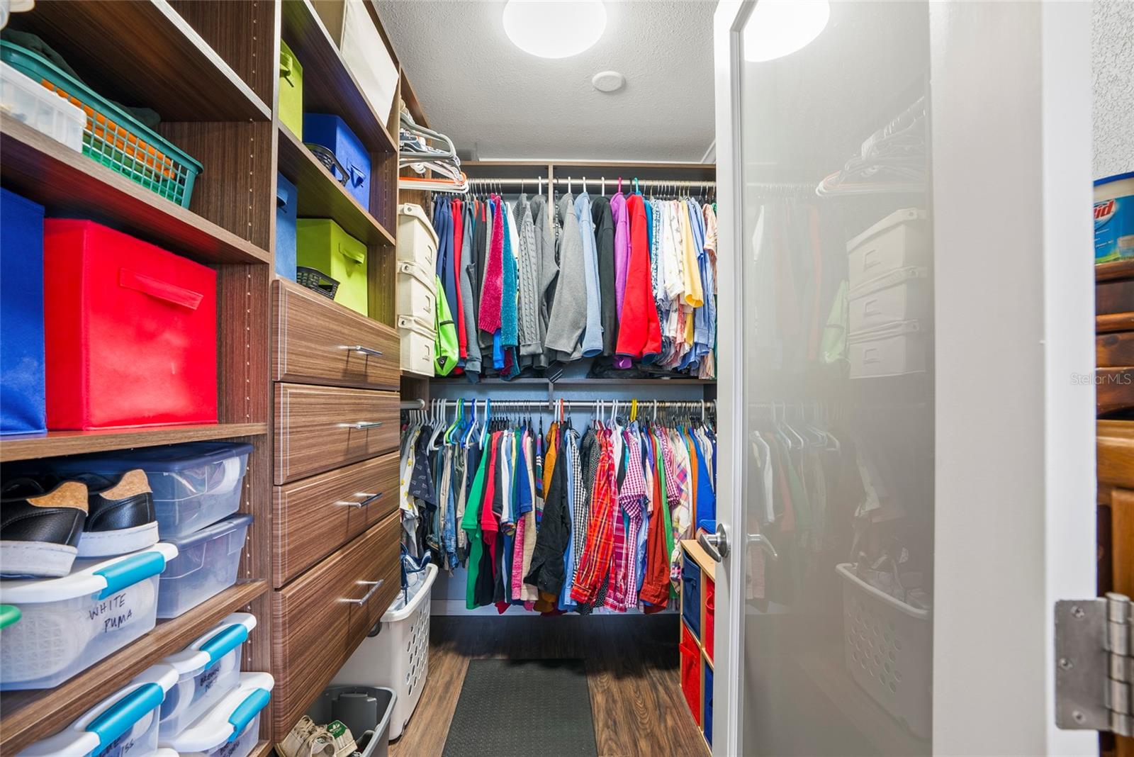 Primary Walk-in Closet with drawers and shelves