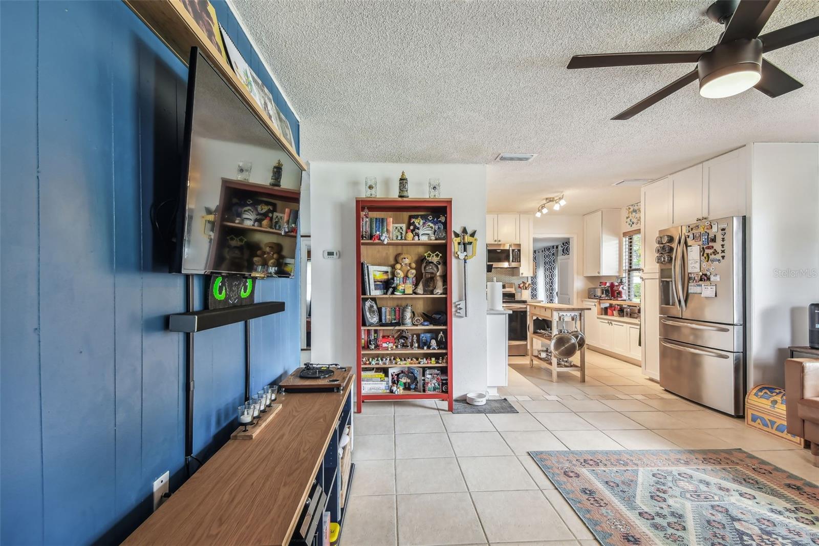 Living room with view into kitchen