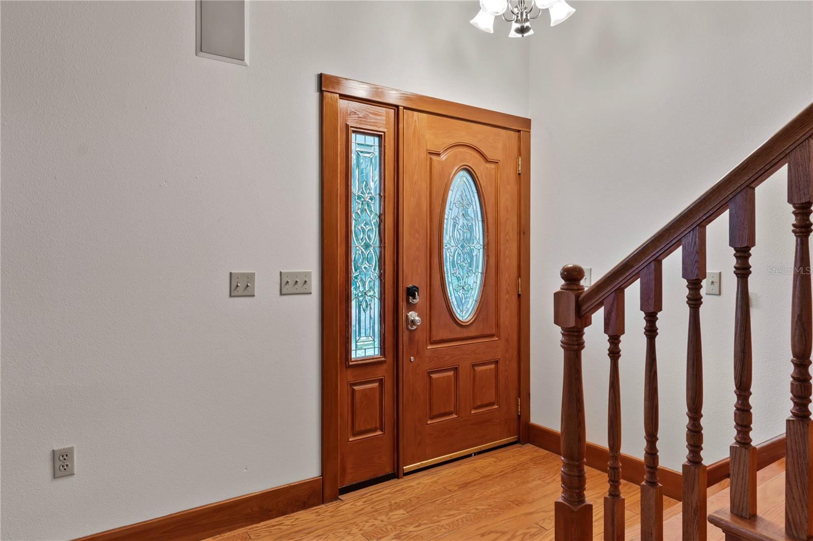 Side light and oval leaded glass door lets in natural light!