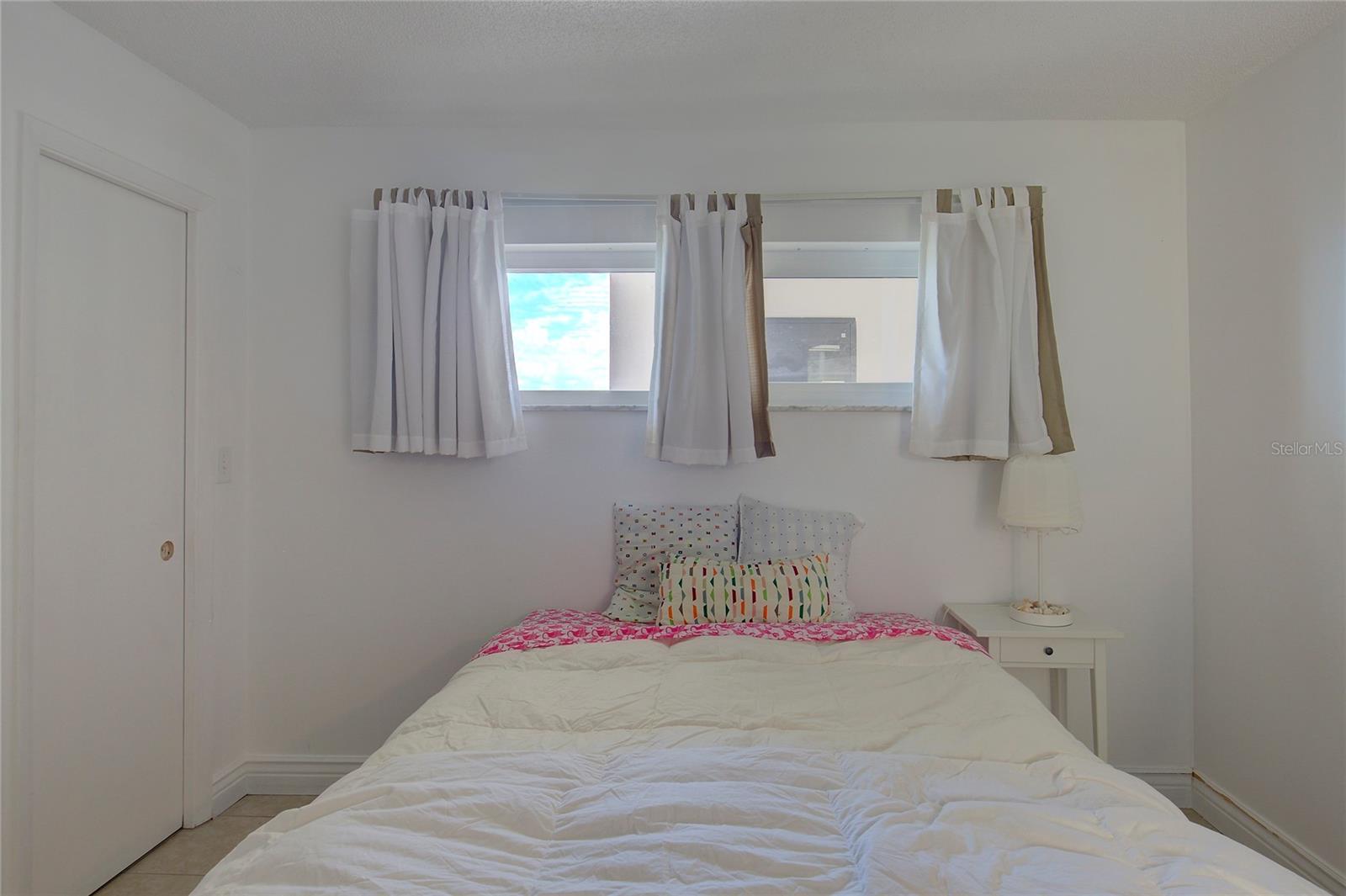 Guest bedroom is generously sized and separated from the master bedroom