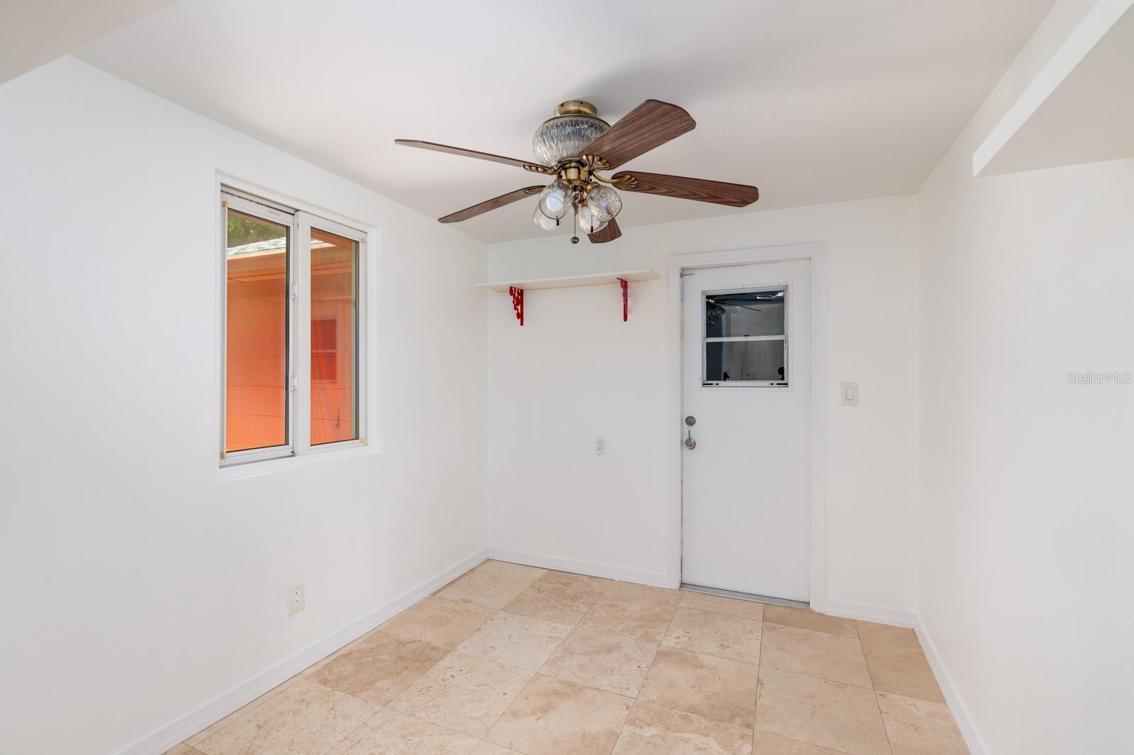 Bonus room w/double pane window & hurricane impact screen. Door to garage.