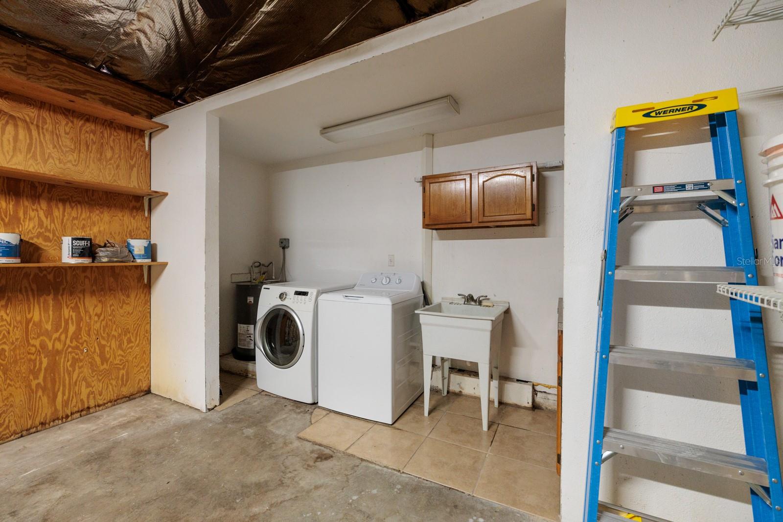 Laundry room in garage w/Washtub. 2024 new water heater & washer.