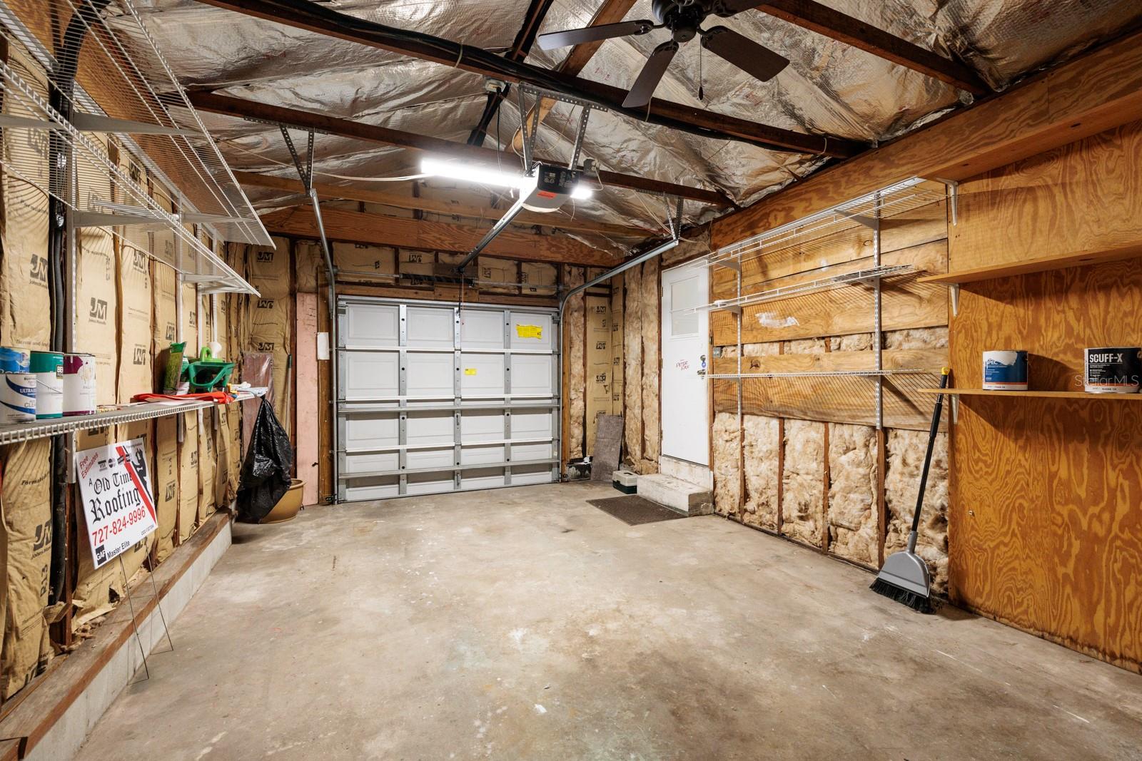 Garage with electric door opener & ceiling fan. Completely insulated.