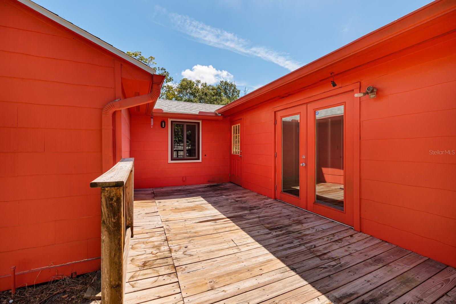 Back porch w/French doors to bedroom, door to kitchen & bonus room window w/Hurricane impact screen.