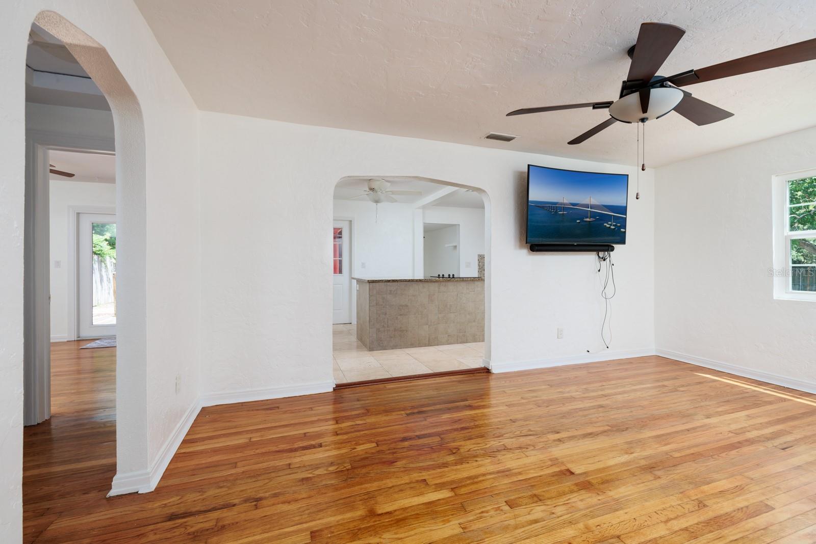 Living/dining room. Kitchen entrance in middle. Hallway to bath & bedrooms on left. Newer Samsung TV conveys.