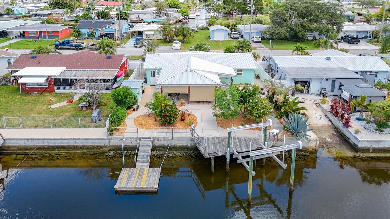 Low maintenance backyard with the deck, boat lift and floating dock, shed and outdoor shower