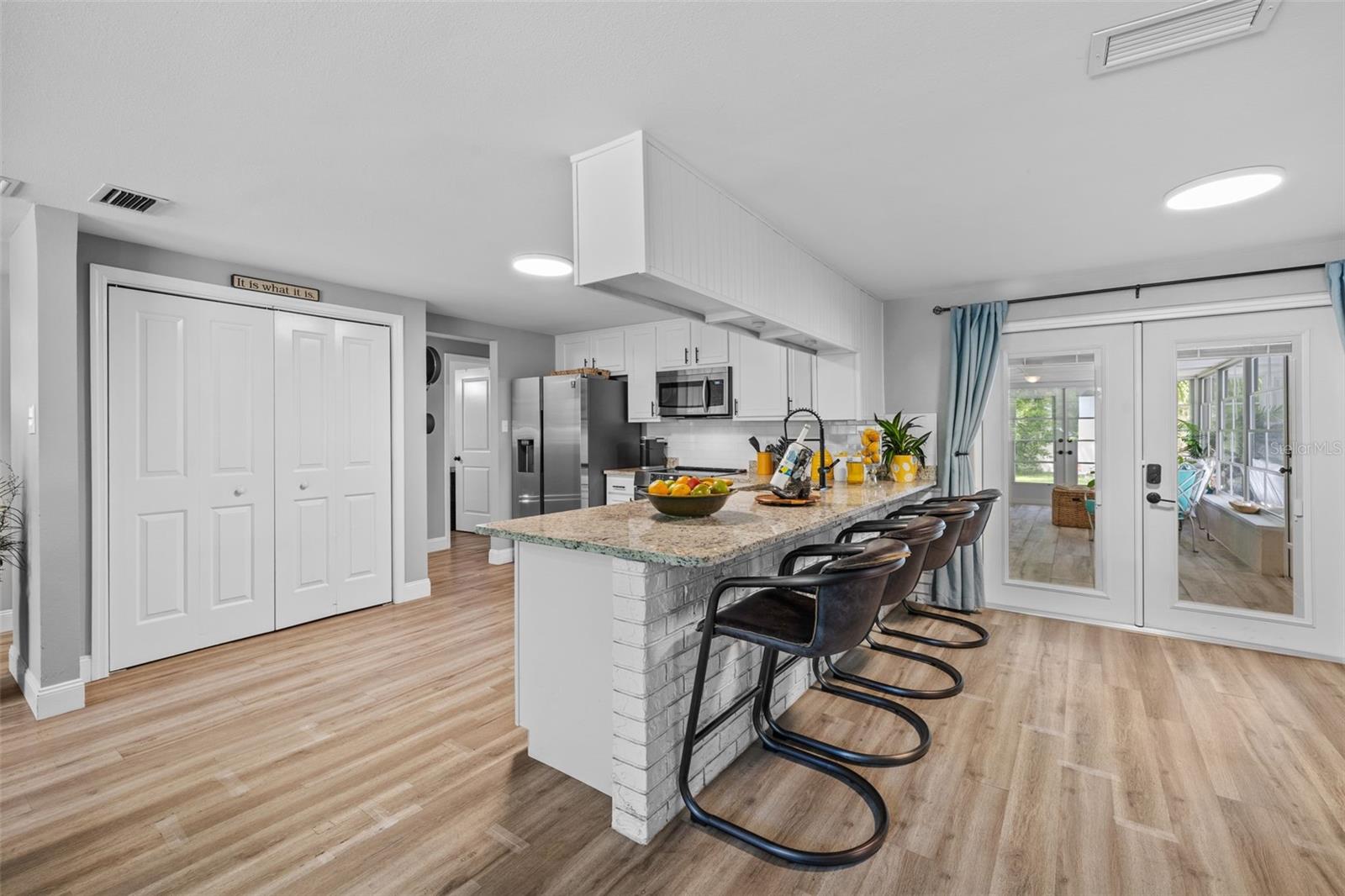 Kitchen counter height bar with view to the Florida room