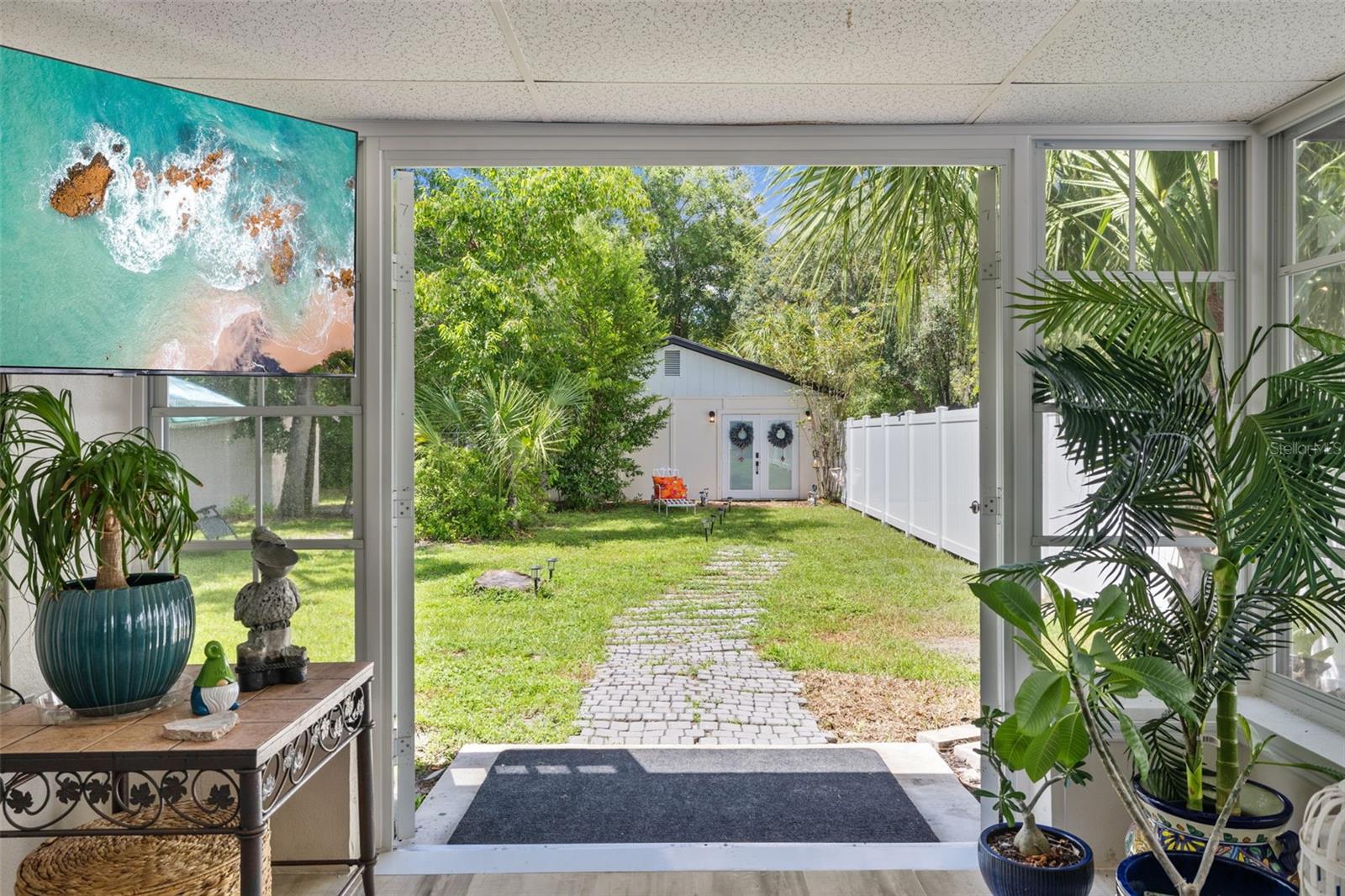 Florida Room/Sunroom with view out back to Guest house