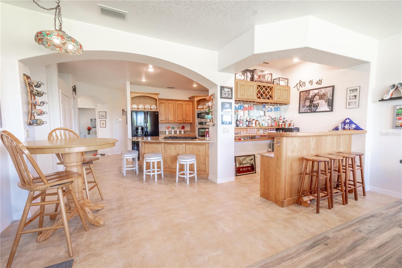 The dining area features a solid wood full wet bar and space for a table.