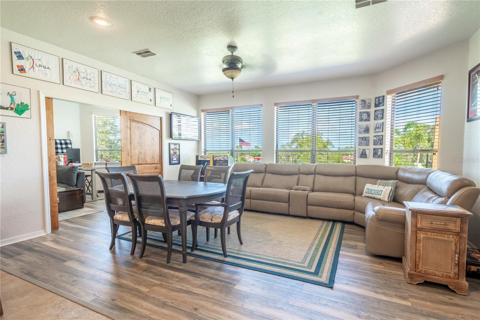 The family room features a wood laminate floor, and a wall of windows with views of Oak Hill Golf Course and the homes private resort like pool area.