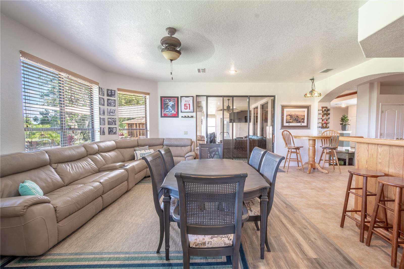 The family room features sliding glass doors that lead to the screened in lanai.