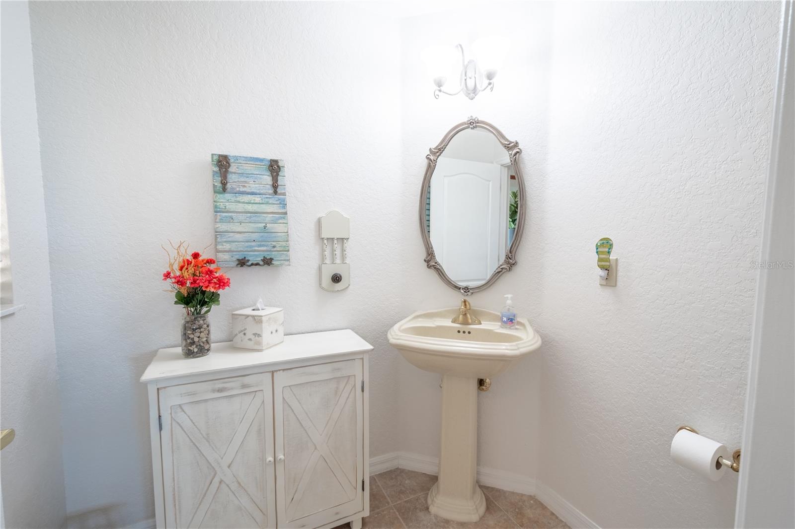 Bathroom 3 is features a pedestal sink and a ceramic tile floor.