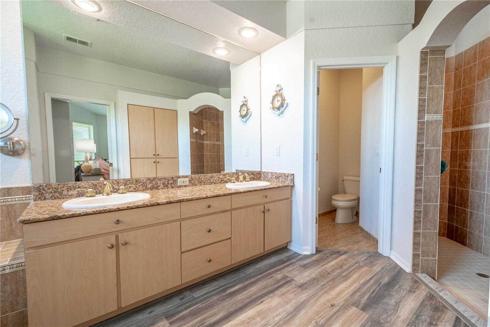 The primary ensuite features a tiled walk-in shower and a private water closet.