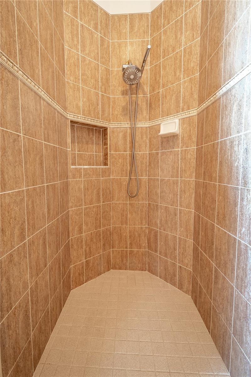 The primary ensuite features a spacious, tiled, walk-in shower.