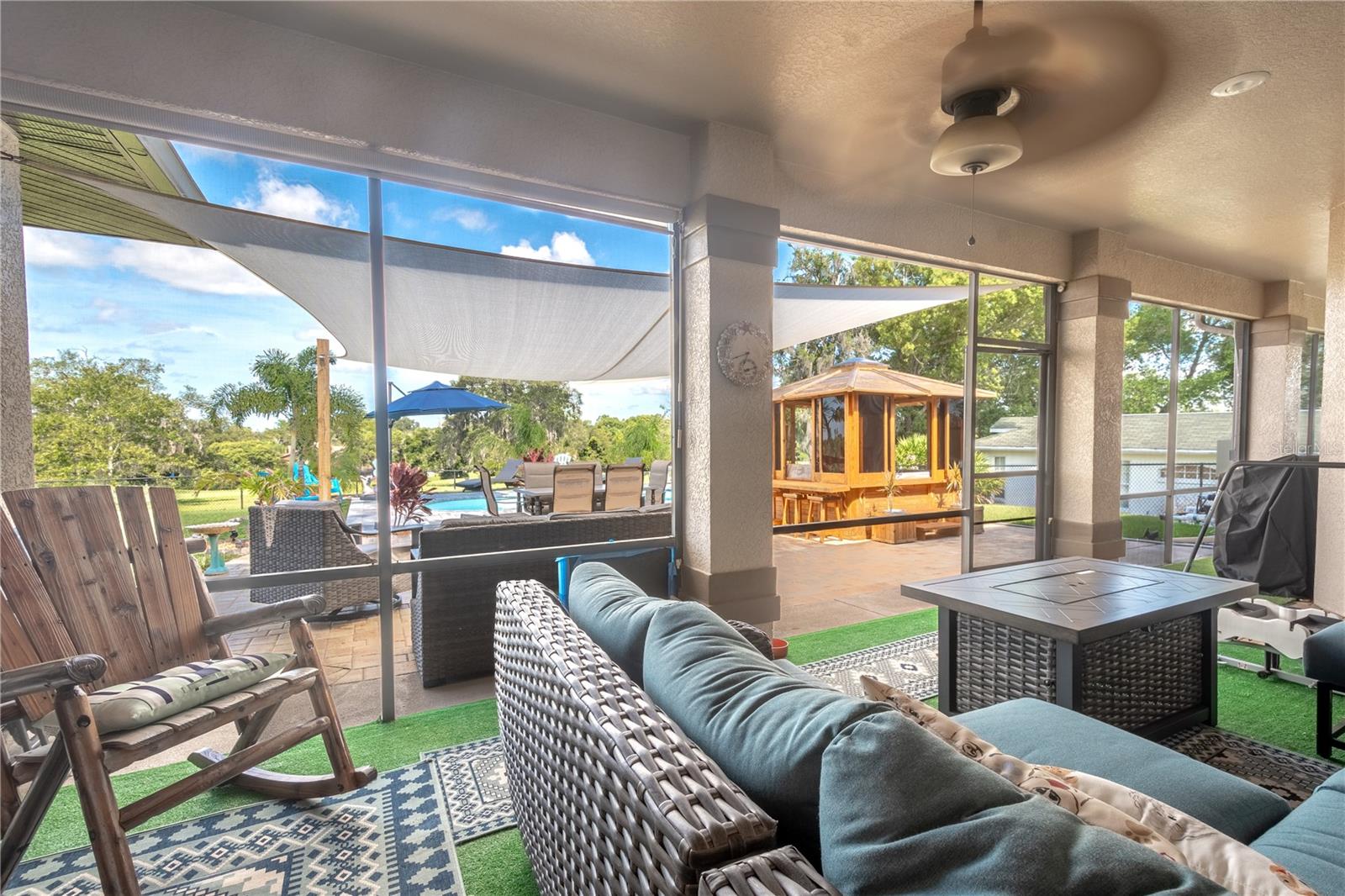 The screened in lanai features ceiling fan for year round comfort, and a view of the pool and golf course.