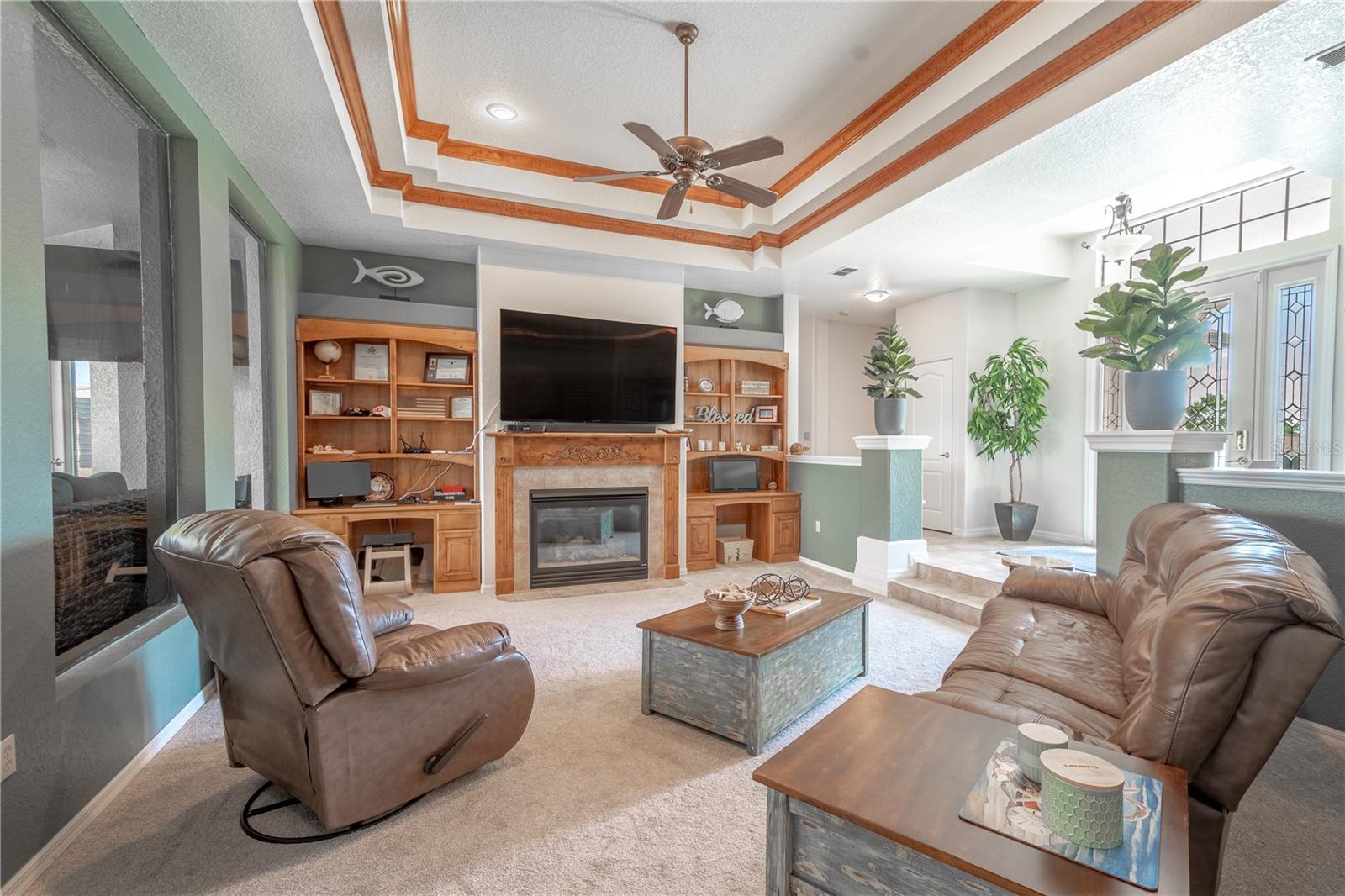 The living room features 2 built-n desks and a gas fireplace.