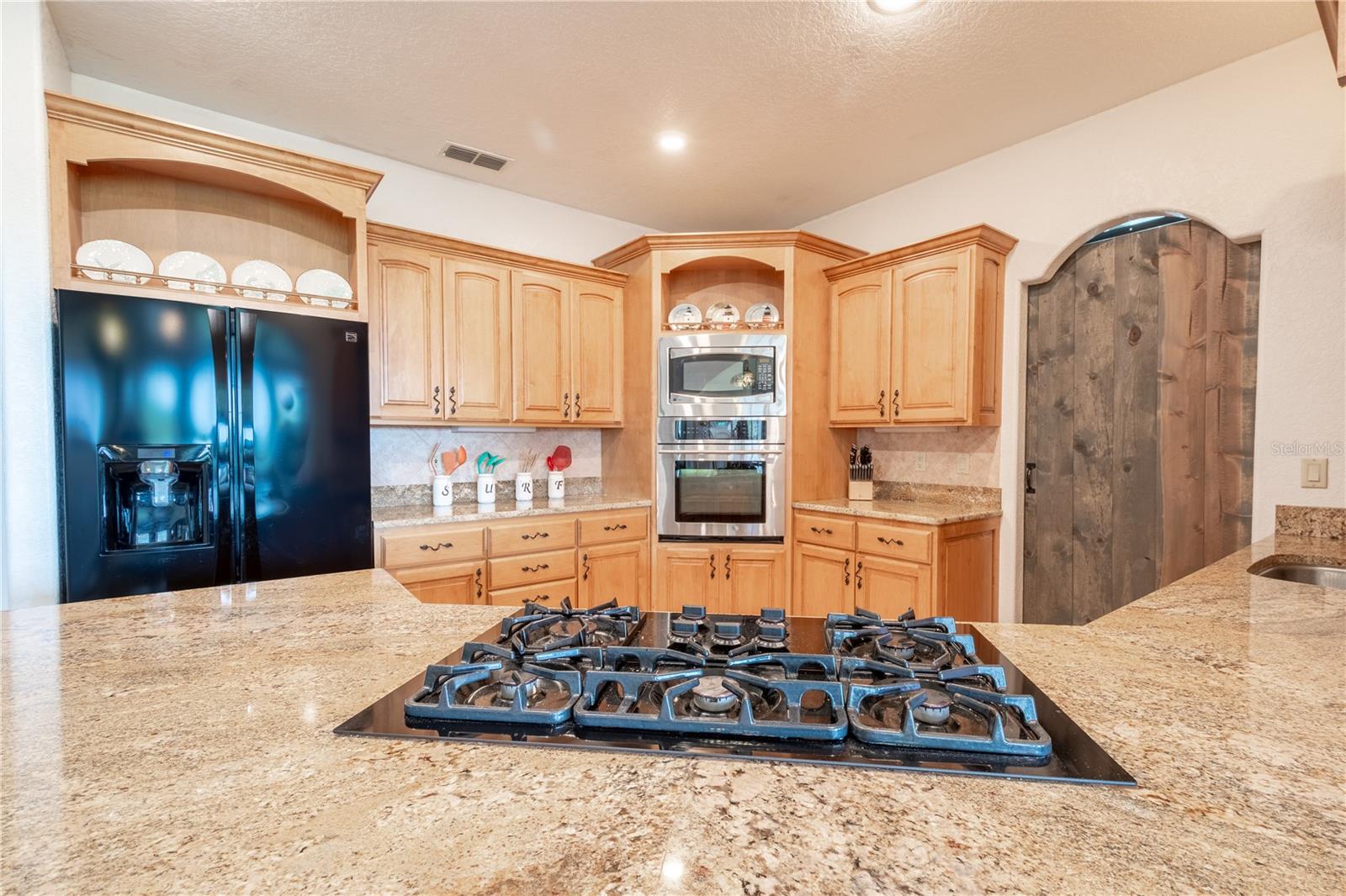 The kitchen features granite countertops, and solid wood cabinetry.