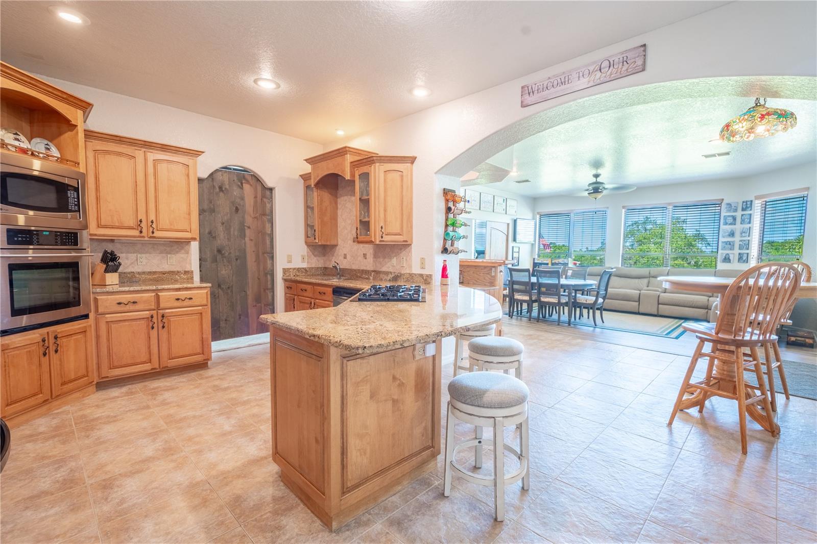 The kitchen features ceramic tile flooring and is open to the family room.