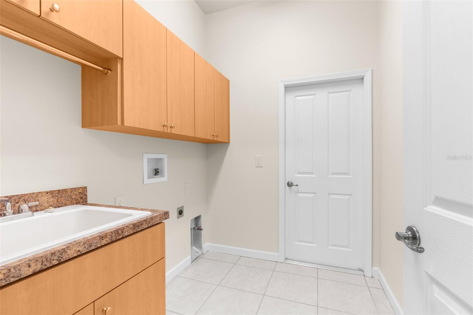 Large laundry room with laundry tub.