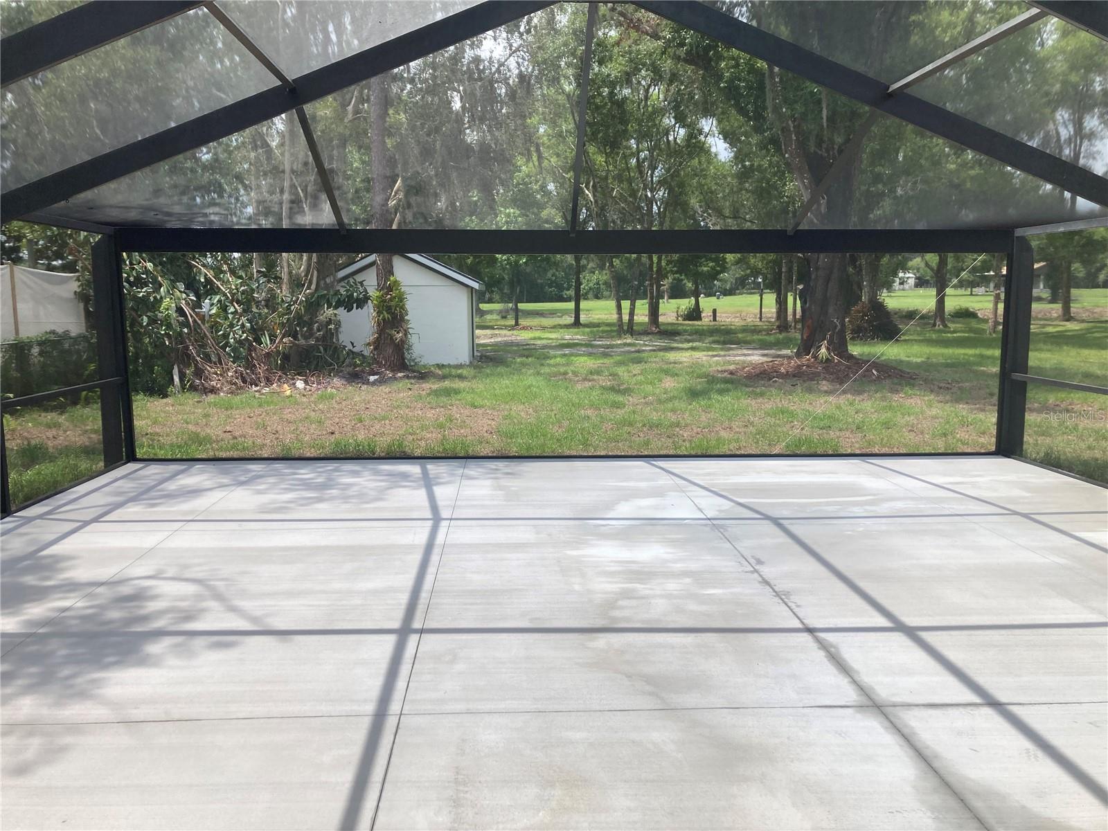 View from front of screened lanai looking out to back property