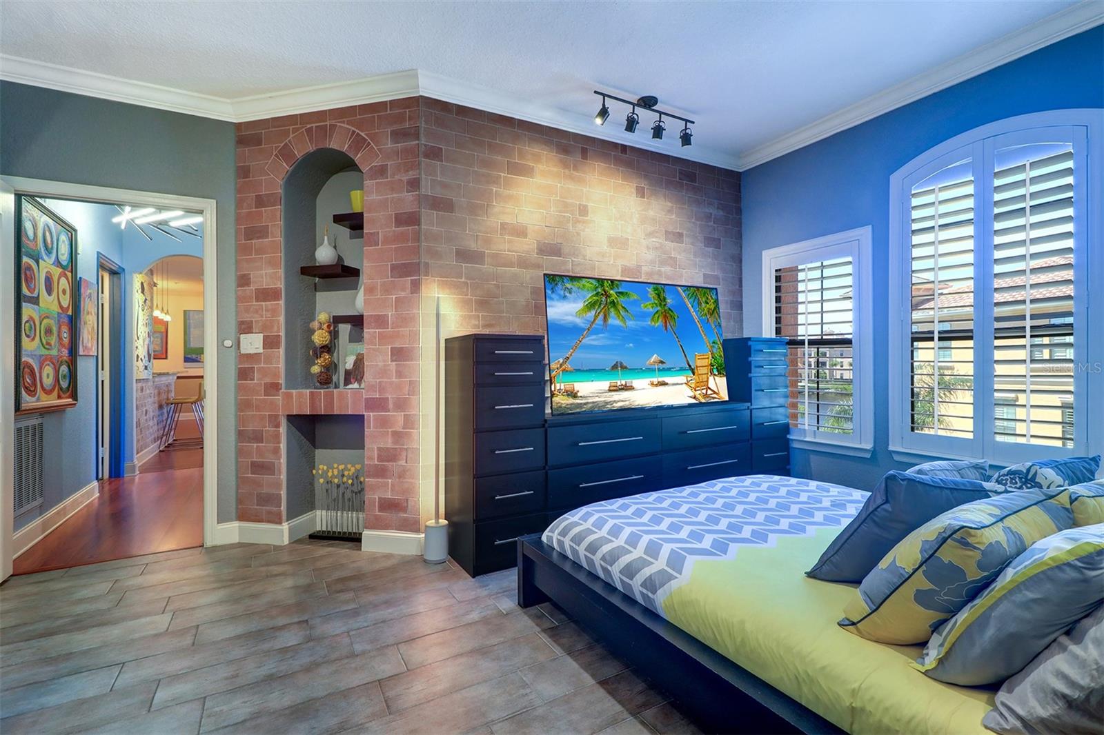 Close up view of primary bedroom interior features with view down the hallway to main living area