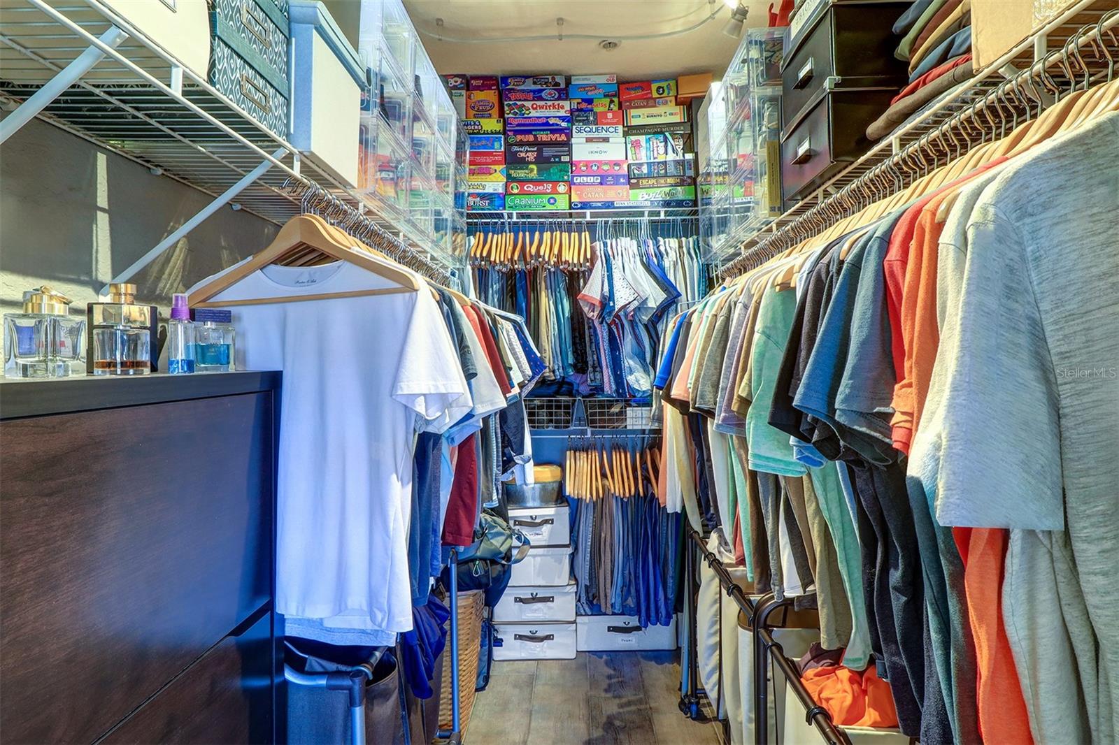 Large walk in closet with organizational shelving