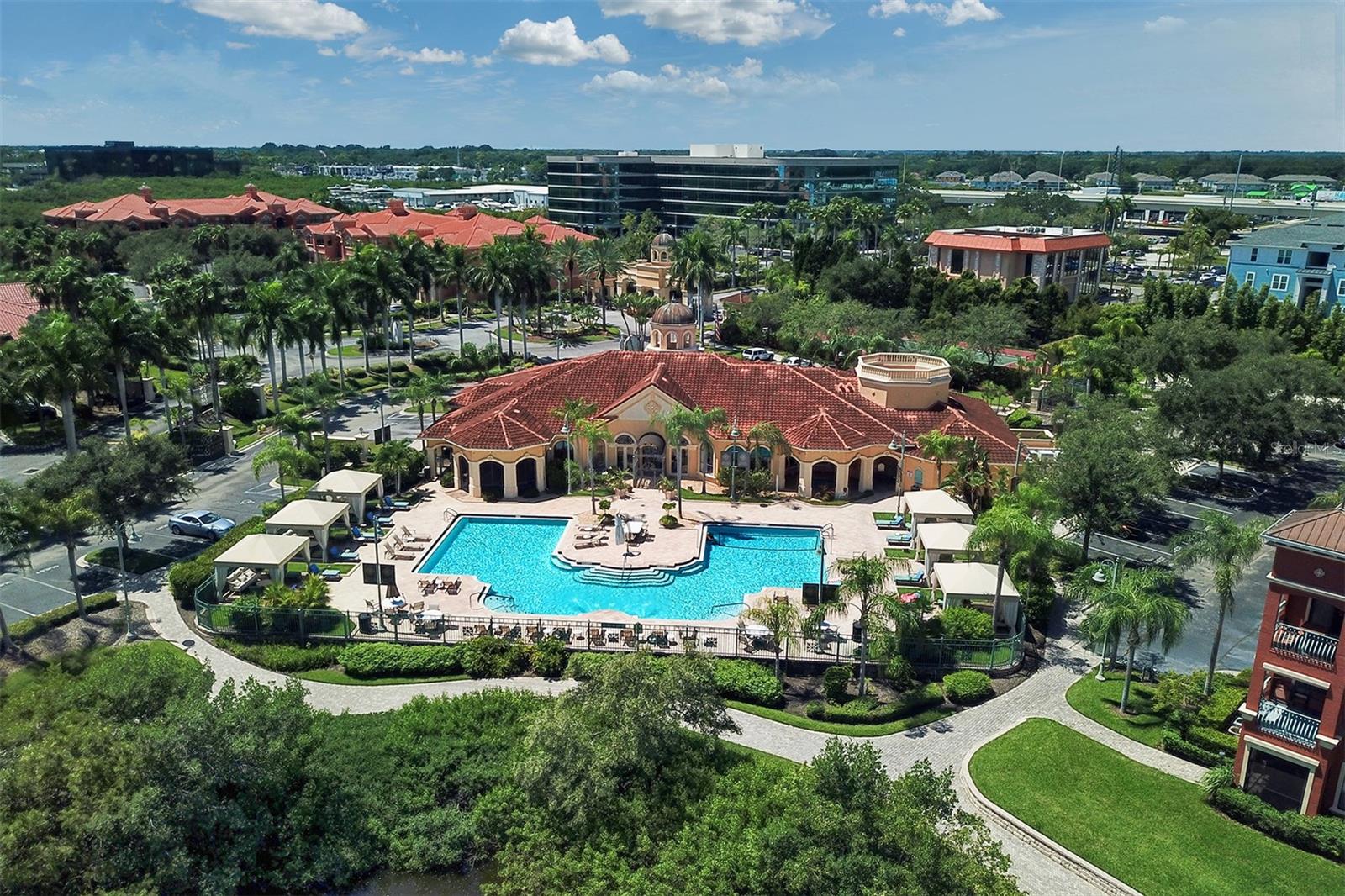 Aerial view of the back side of the Grand Bellagio clubhouse with pool and spa on the inlet