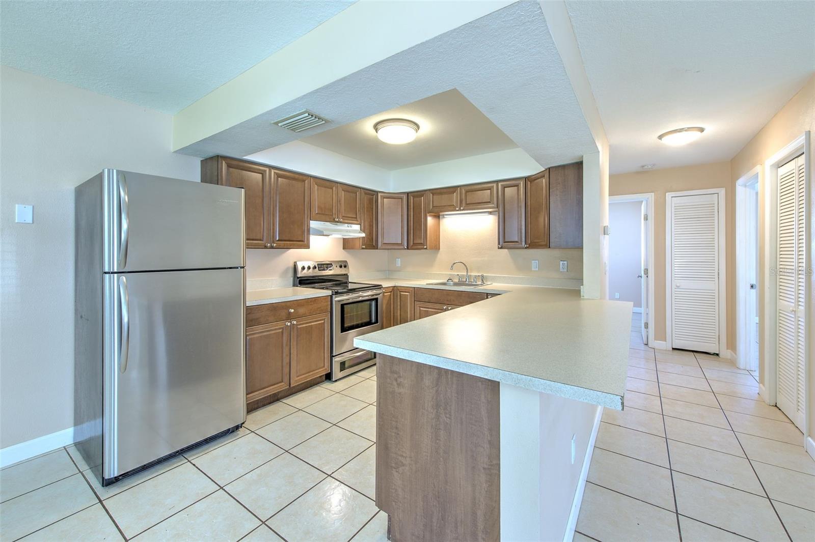 Kitchen with view from living room, dinette with view to the front door and flex space to the left