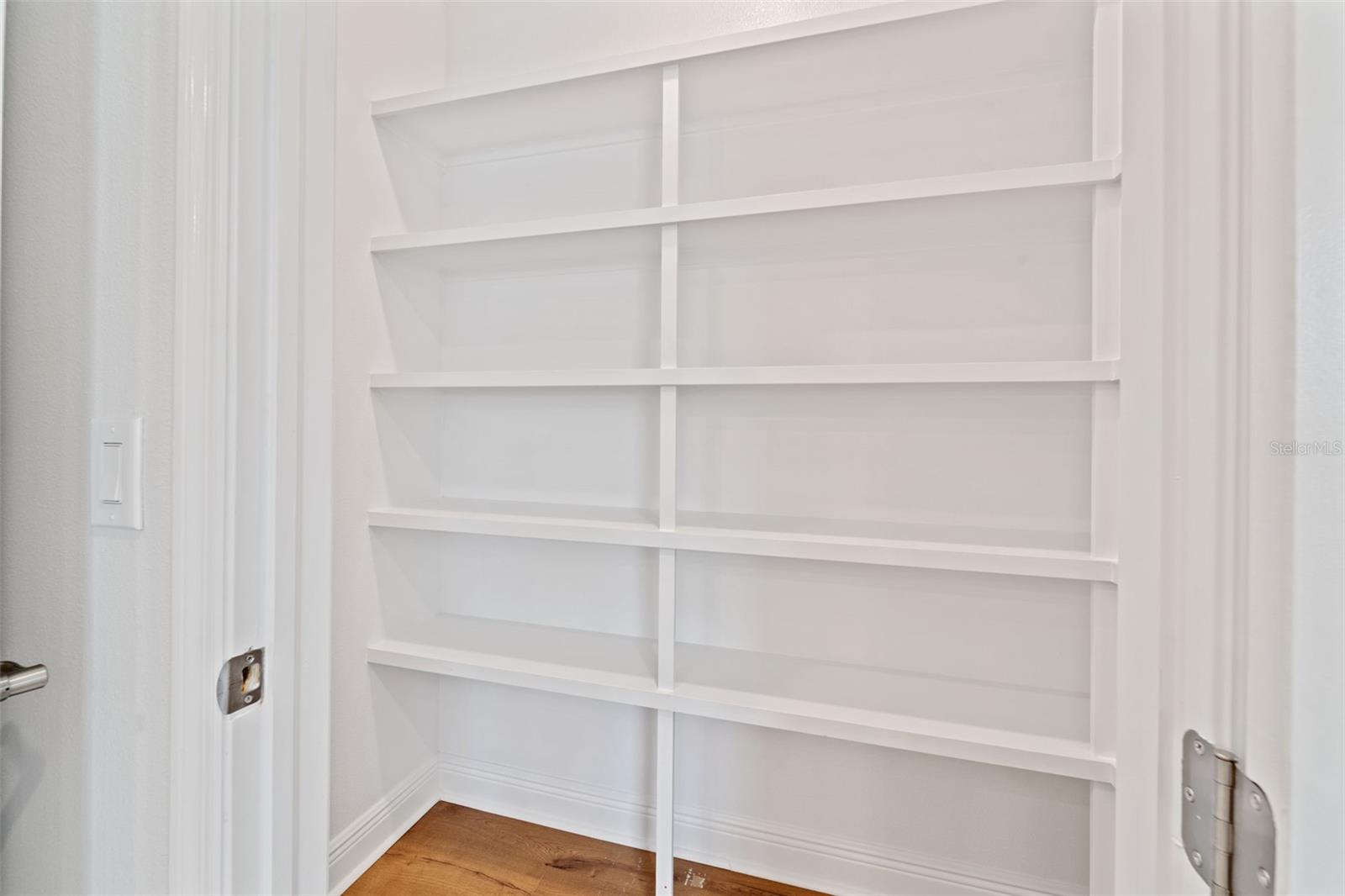 Custom Pantry off across Kitchen Island