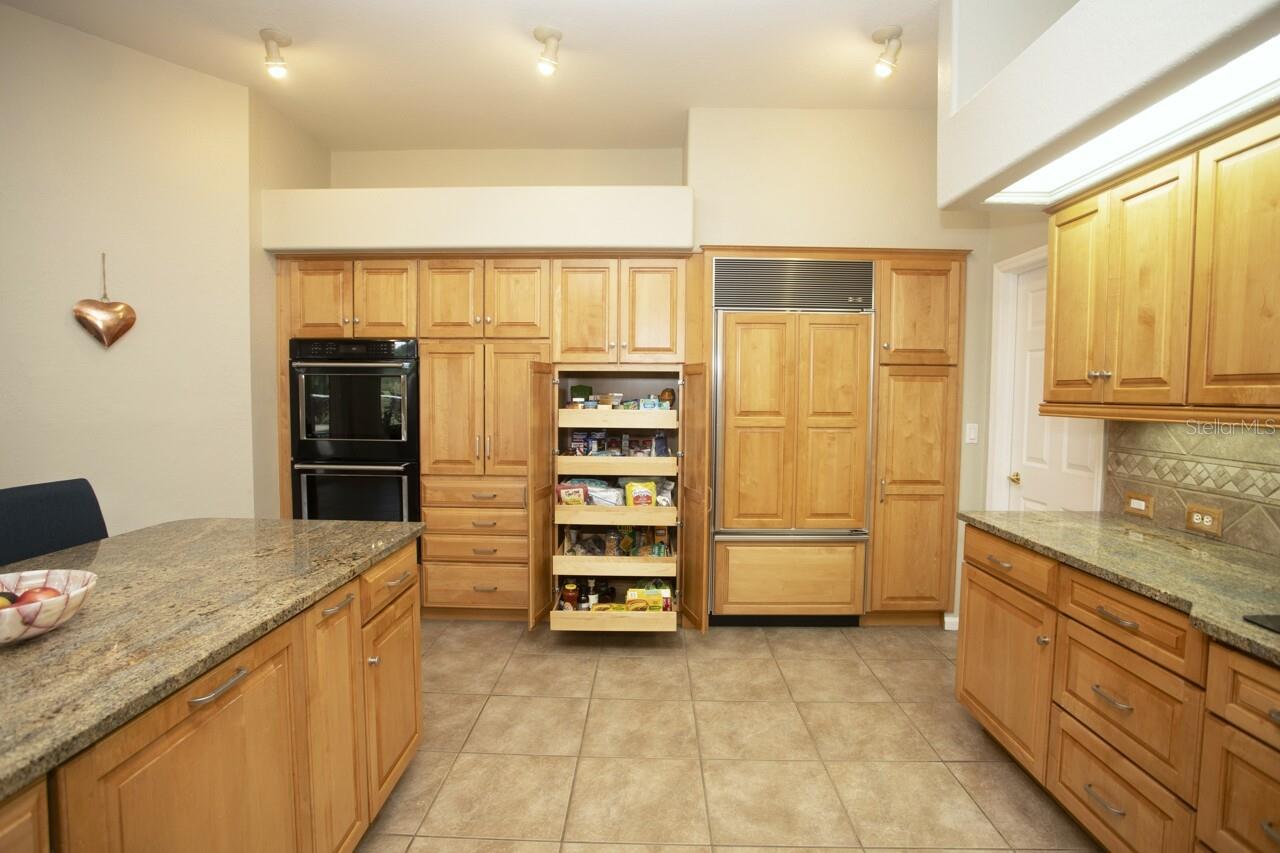 Kitchen, double ovens, cabinetry and pantry pulls, paneled Refrigerator