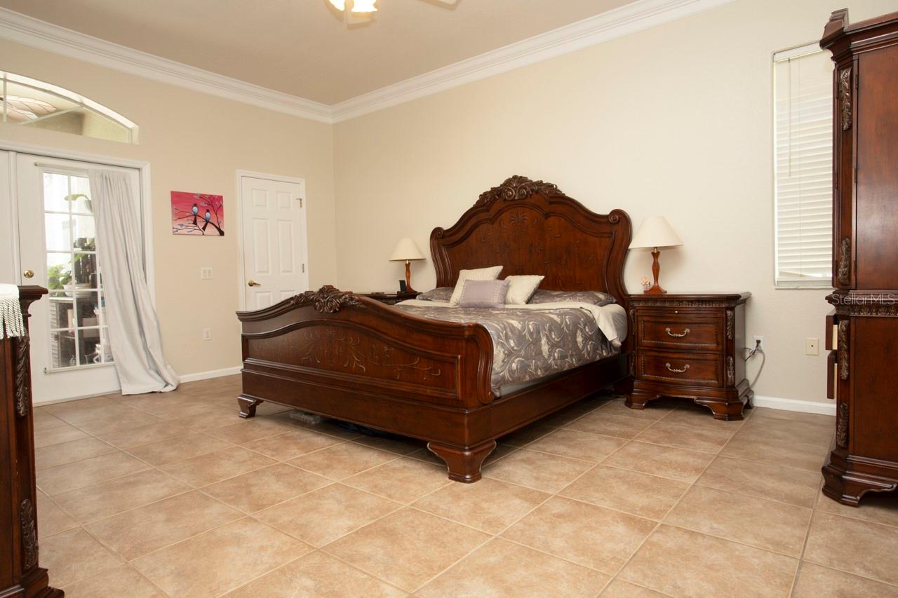 The ultimate Master Bedroom for large furniture, double walk-in-closets, double French Doors to the Lanai & Pool