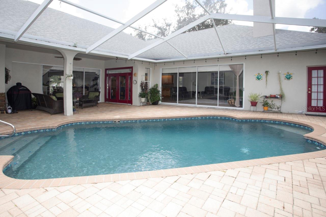 Enjoy the warm Florida sunshine by your Pool ...view of the covered lanai from the pool