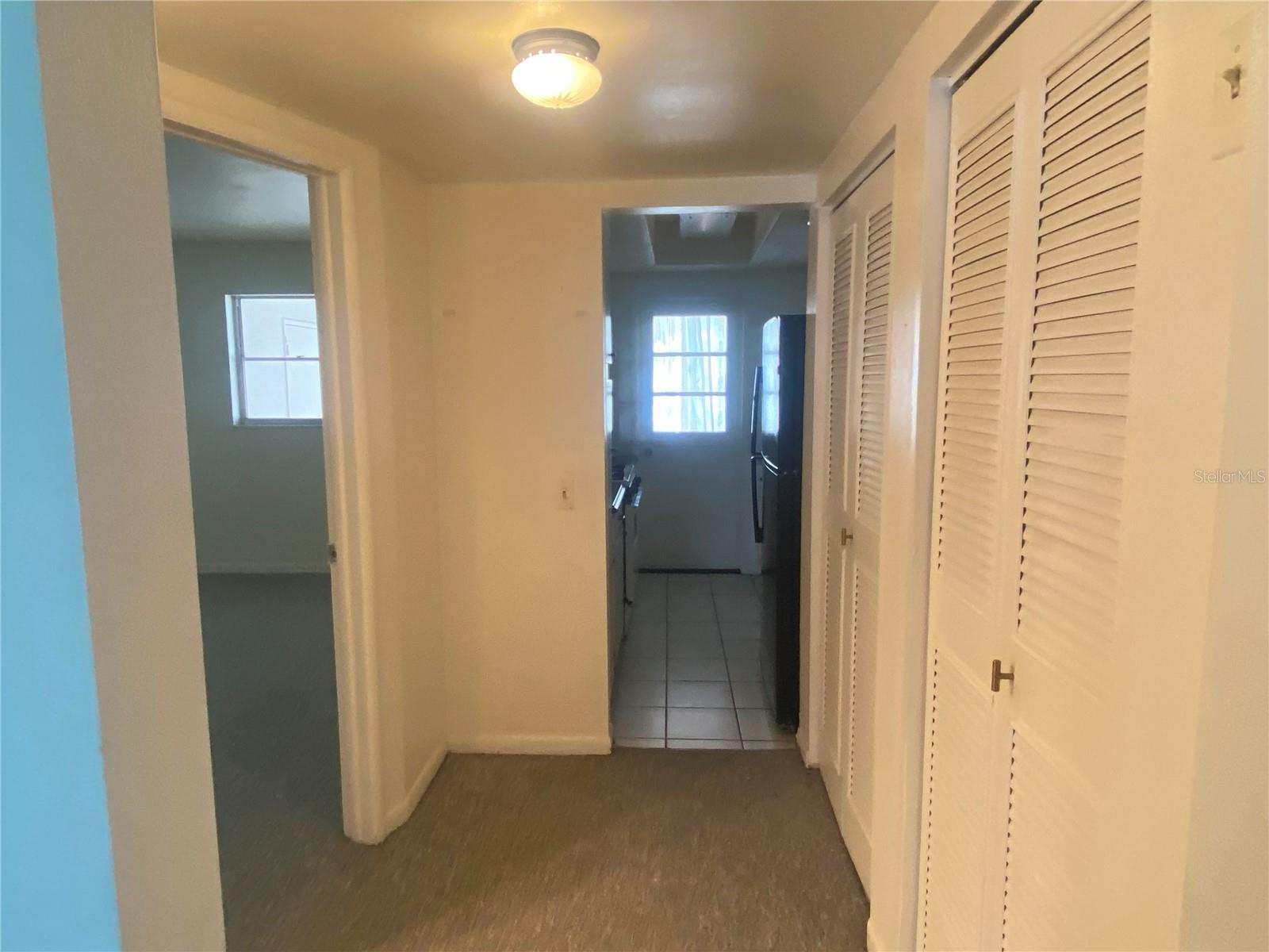 Standing in the dinette area, view into the hall. Bath to your immediate left, then bedroom. To our right is the HVAC closet - This is a furnace & gas provided by Association & included in Monthly maintenance fee.  Next to HVAC clsoet is a storgae closet. Straight ahead is the partially updated kitchen, the the Florida room.